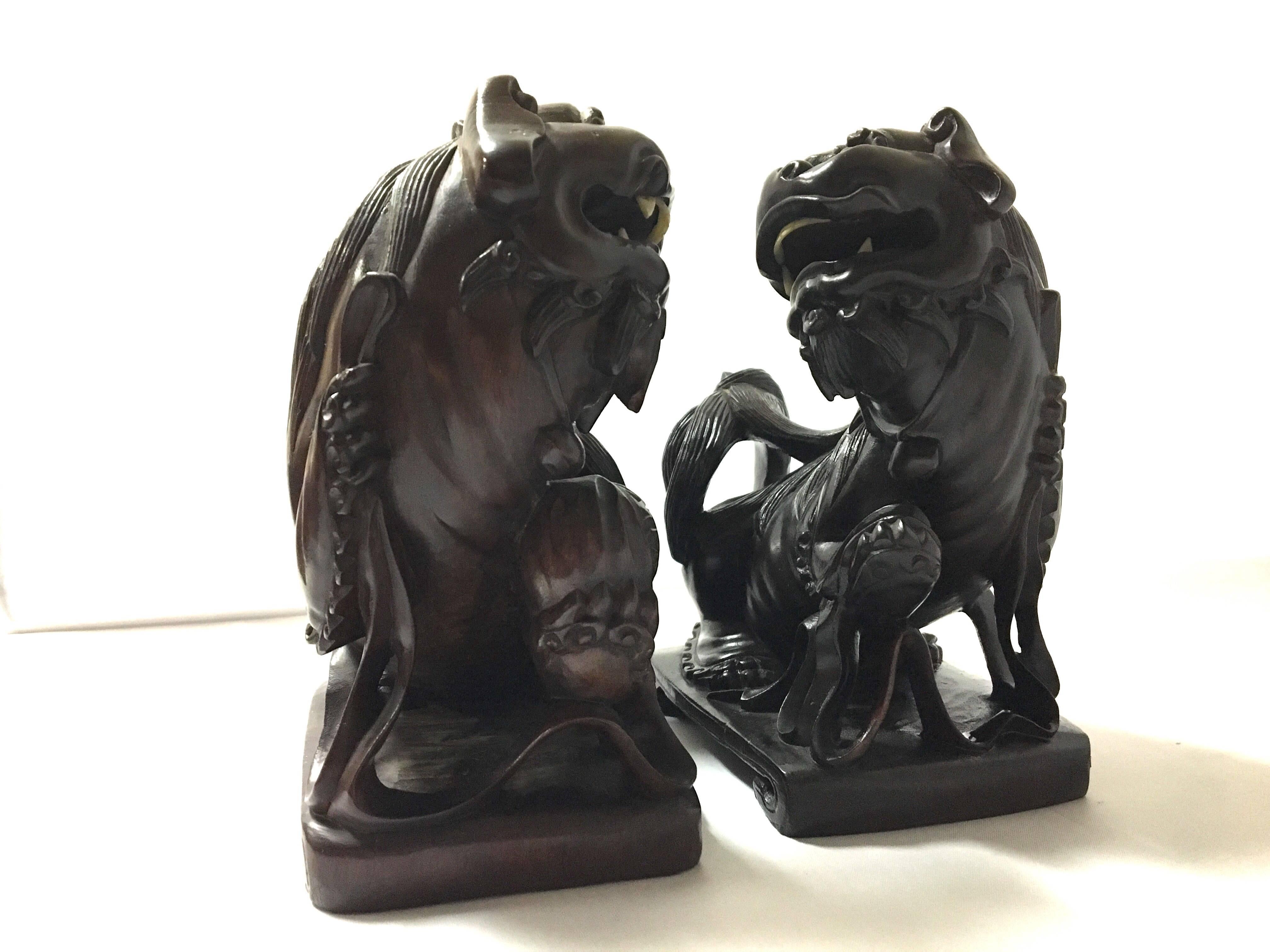 A very nice pair of vintage hand-carved Chinese foo dogs or lions bookends which I believe are hand-carved from rosewood. Excellent condition.