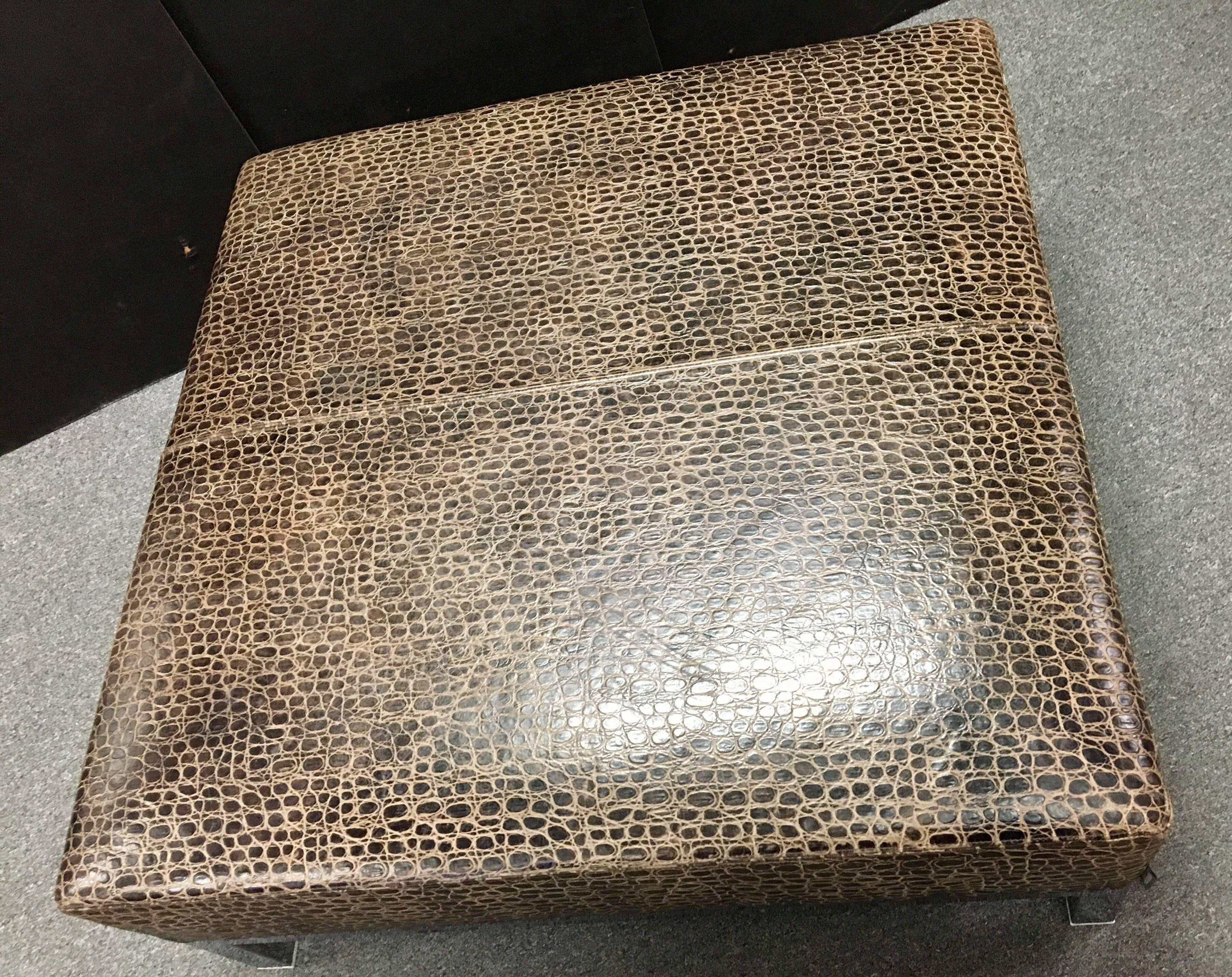Elegant, contemporary and large ottoman or coffee table by Italian furniture maker Minotti. Stylish crocodile patterned leather on a polished chrome square base with adjustable plastic feet. Wonderful piece that will be the focal point of any room.