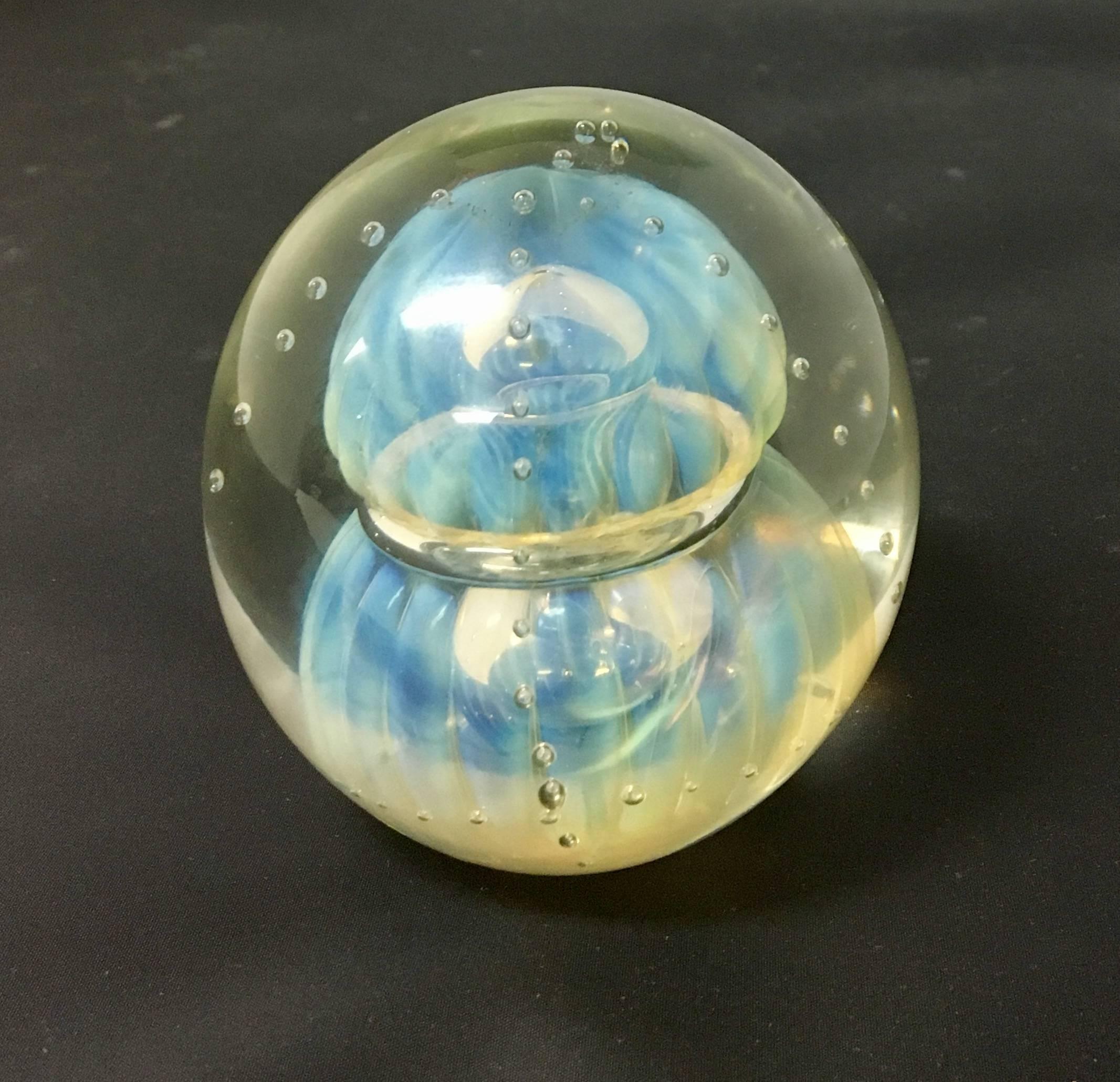 Beautiful and unique blown glass paper weight signed and dated "1987" by Edols. Clear glass with a white jellyfish like shape and bubbles that gives the illusion of being lit. Very high quality.