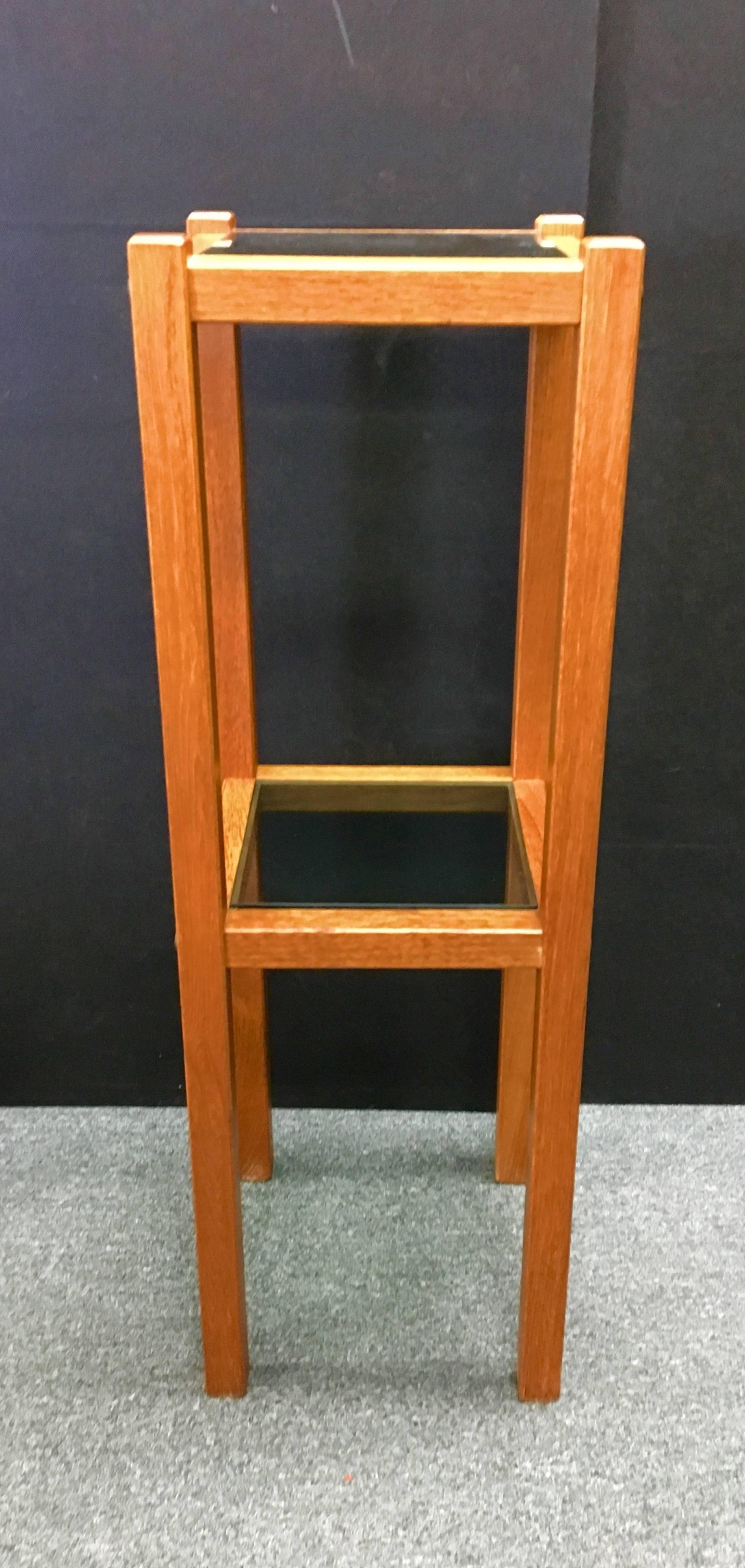 Very functional two shelf Danish modern teak plant stand. Shelves are smoked glass.