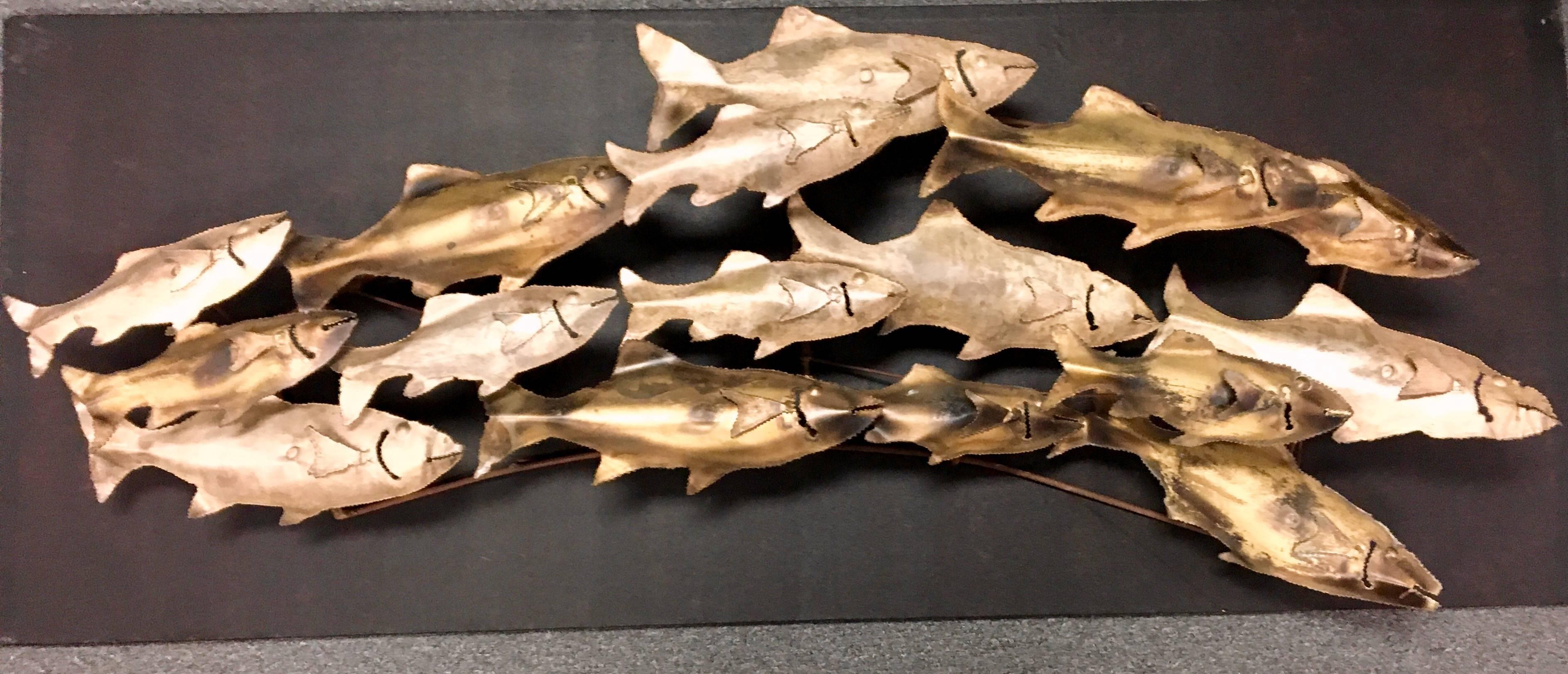 Large school of fish wall sculpture, circa 1960s. The fish have brass and a light silver finish. Excellent quality construction and condition. Unsigned.