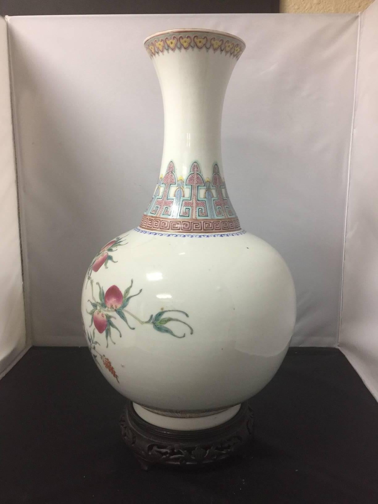 Spectacular and rare, tall (18") porcelain famille rose vase on a 2" wooden stand. The piece is in excellent vintage condition and bears the mark of the Hongxian period dating it to early 20th century. A Hongxian mark on a non-imperial
