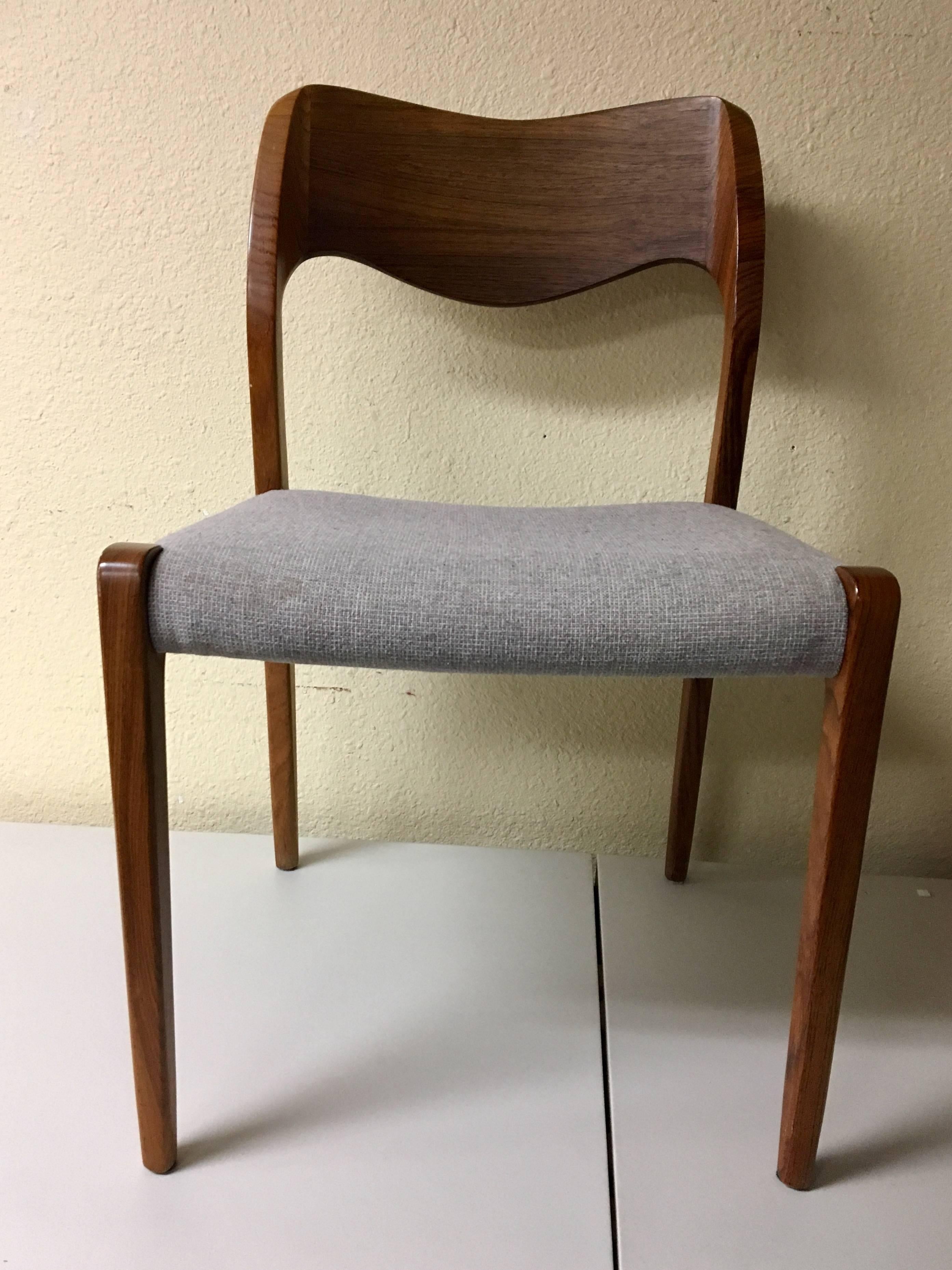 A very nice set of six rosewood dining chairs designed by Nils Moller, circa 1970s. The chairs are solid rosewood construction with light grey upholstered seats. The set is in very good condition; seats are lightly worn and show fading and light