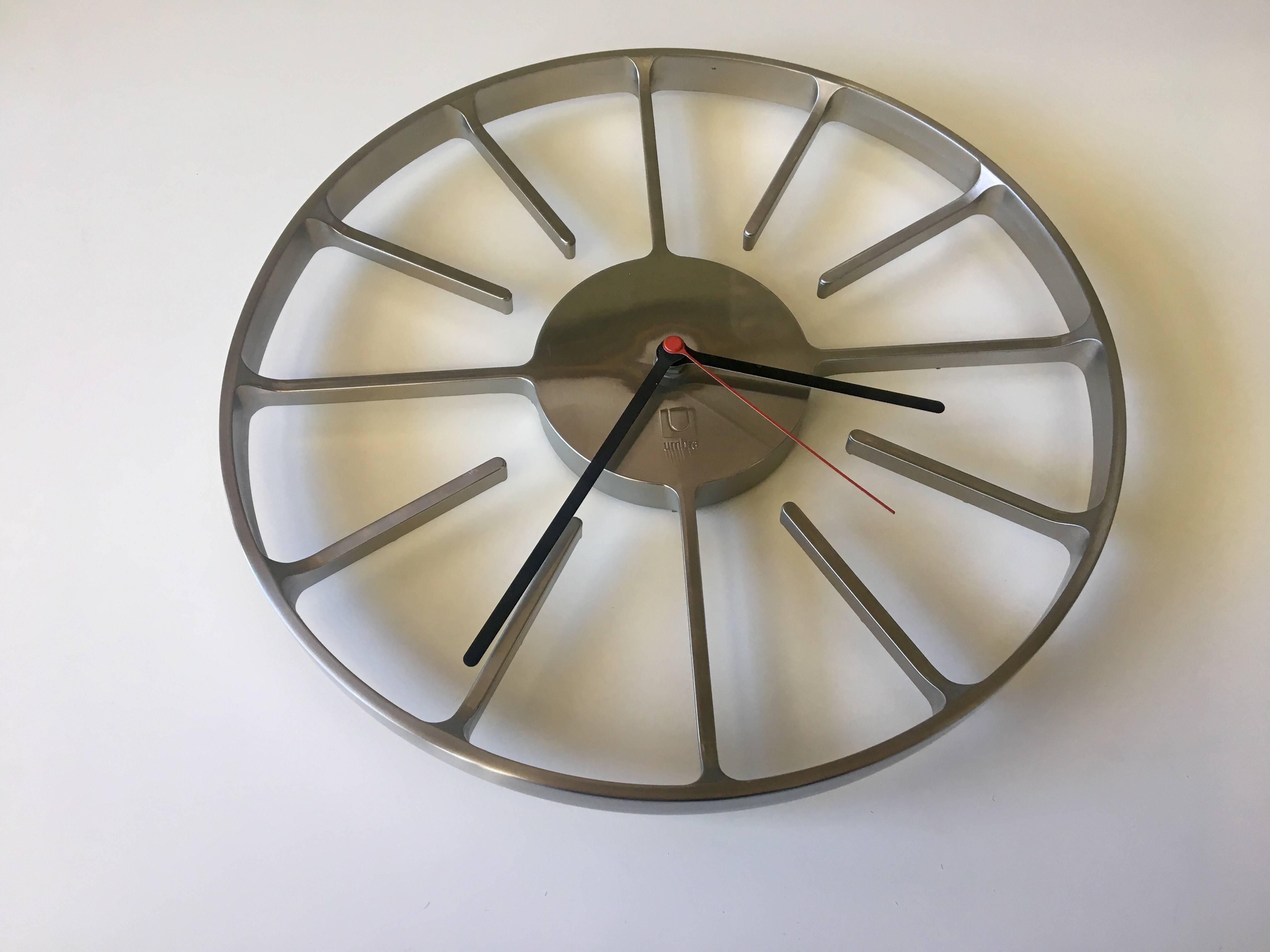 Rare solid polished stainless steel car wheel style, wall clock by Umbra, battery operated movement, circa 1990s.