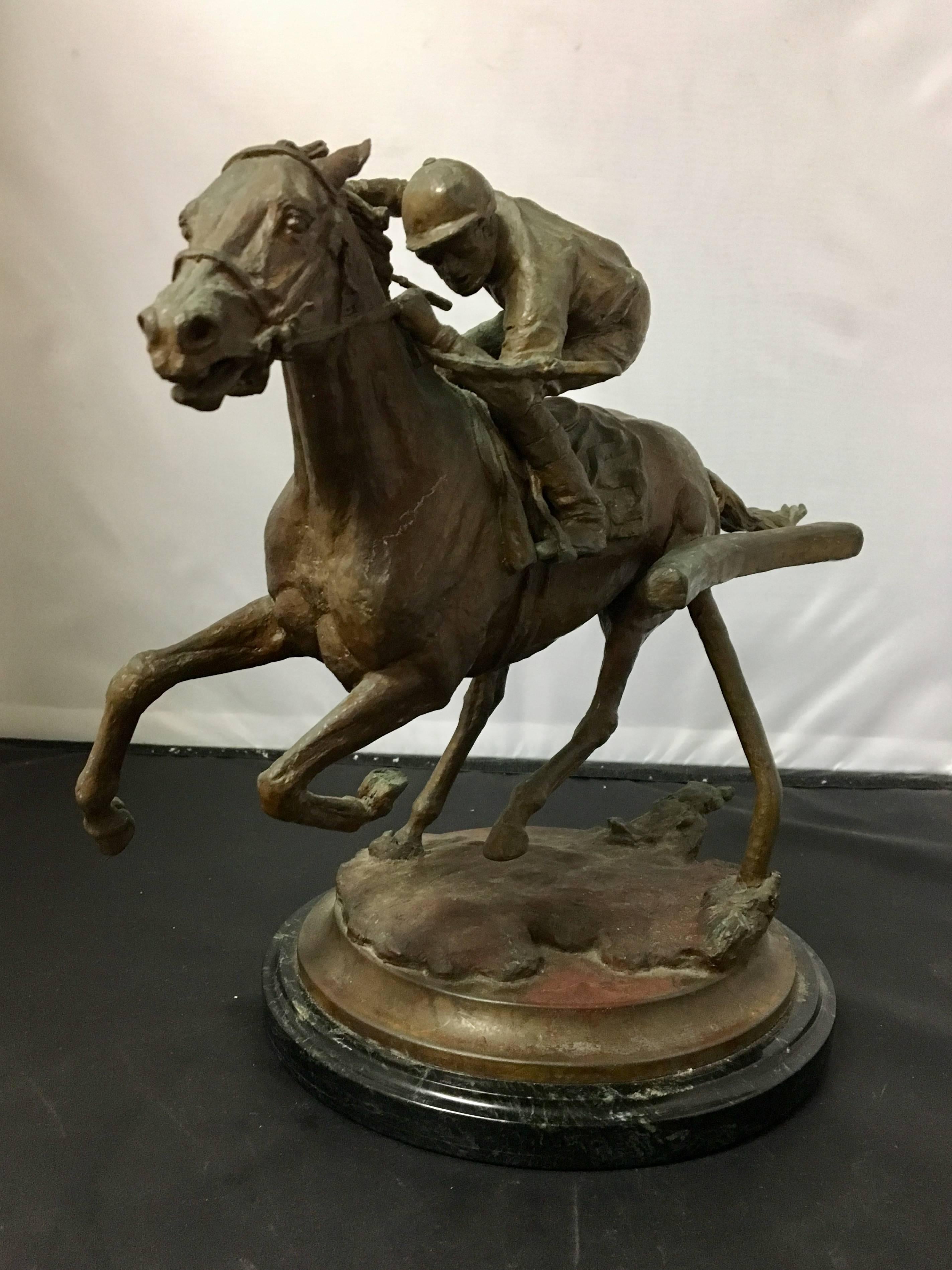 Exceptional bronze sculpture of a thoroughbred horse and jockey in full gallop by noted equine sculptor and artist Elizabeth Guarisco. The piece is signed and dated "1990"; it is also numbered 13/24. The sculpture sits on an 8.5"