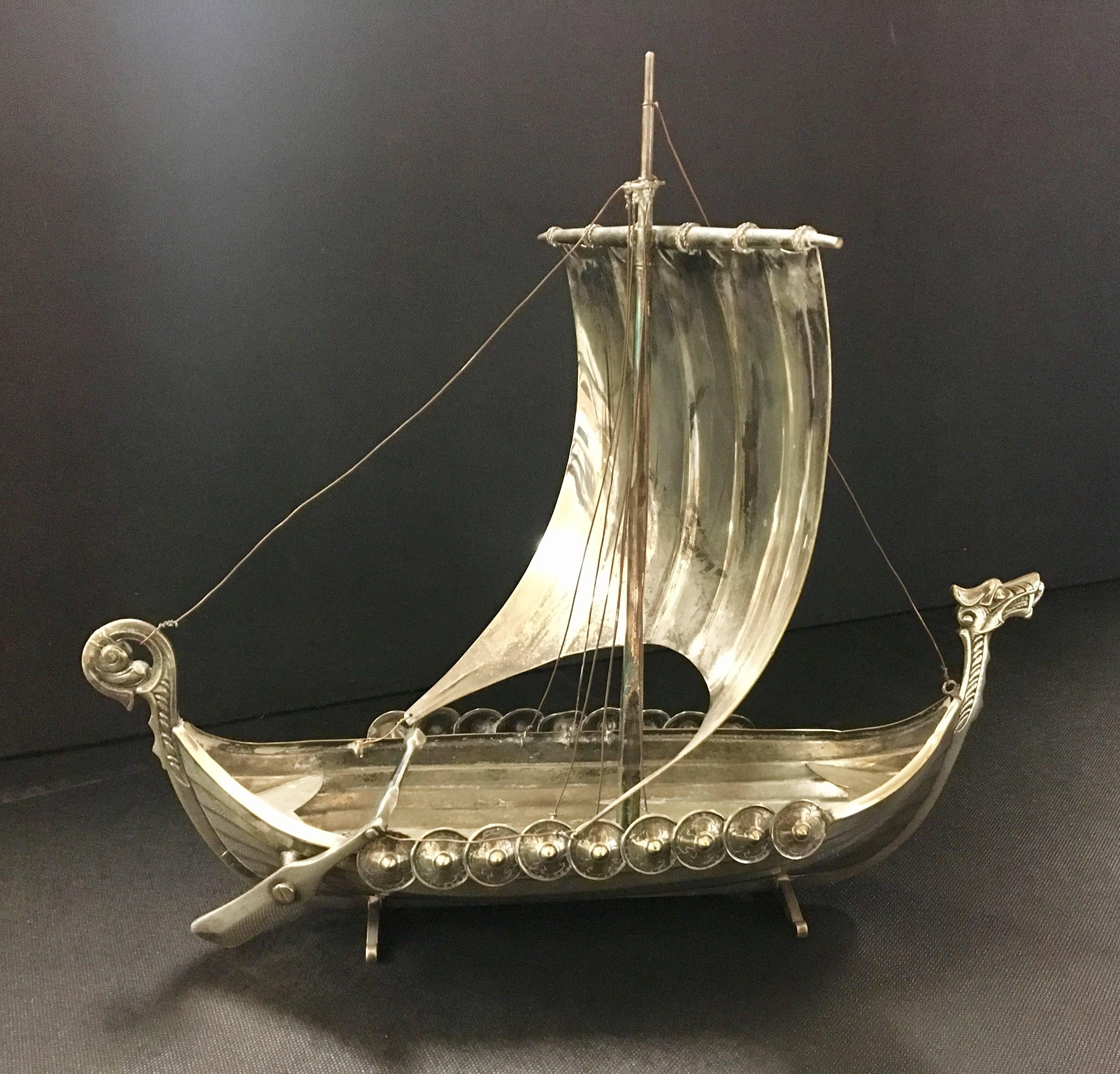 Excellent detail in this miniature, reproduction viking ship made of silver plate and brass. The ship has an excellent vintage patina and is stamped "Victoria".