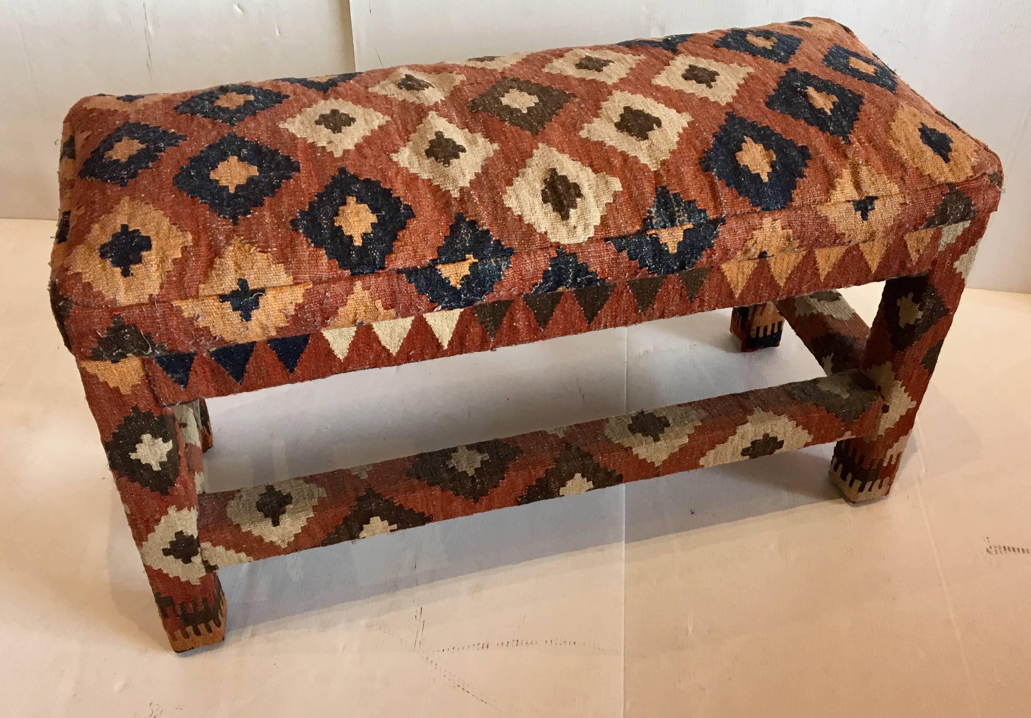 Beautiful and hard to find vintage Kilim rug bench designed by Robert Noel Designs, of Carmel California, circa 1980s, His designs were made with antique rugs and kilims that he salvaged, signed with a brass plaque. Solid and sturdy.