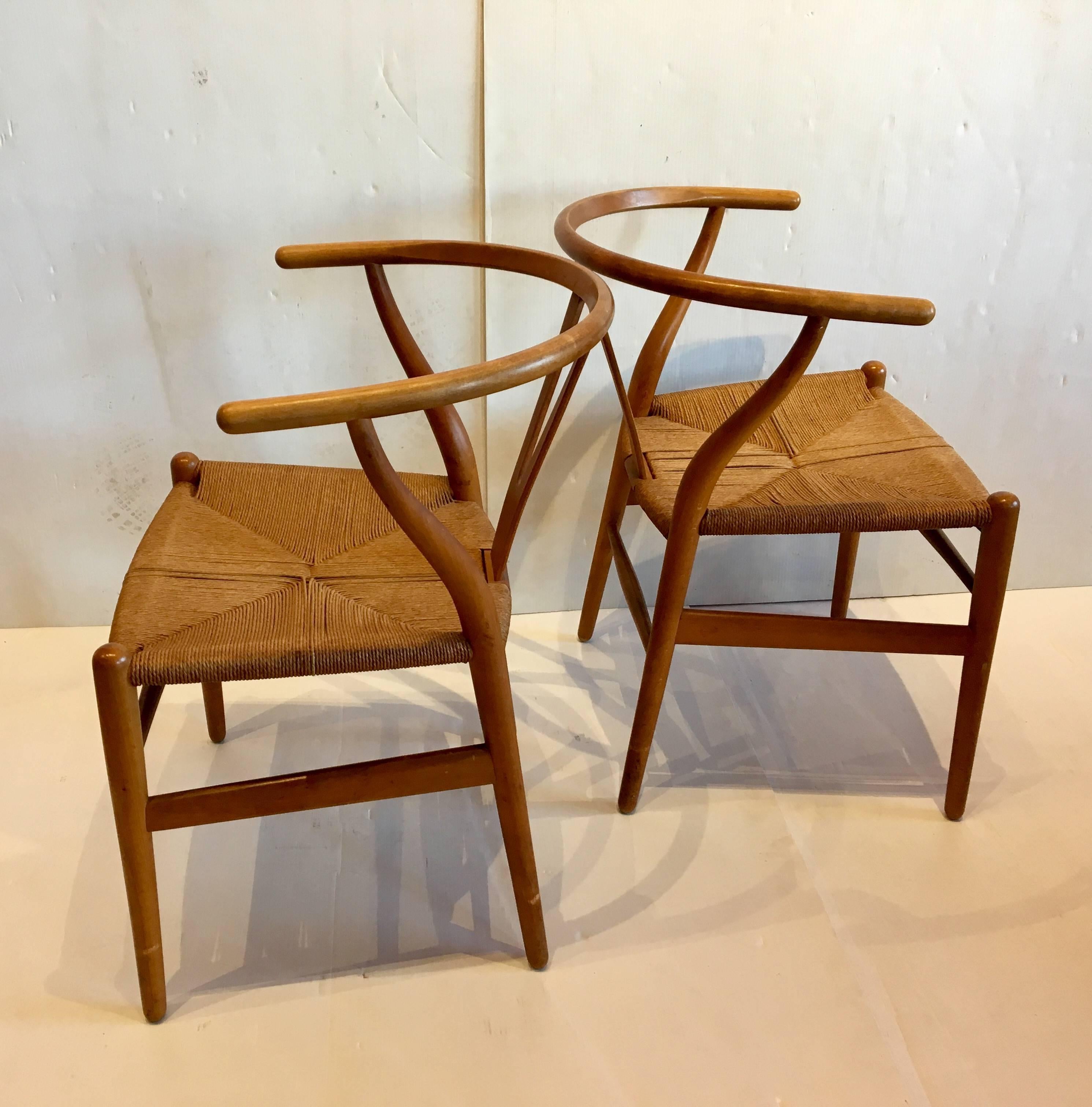 Nice pair of Wishbone chairs design by Hans Wegner with original rope seats. Great condition in birchwood finish with a walnut stain.
