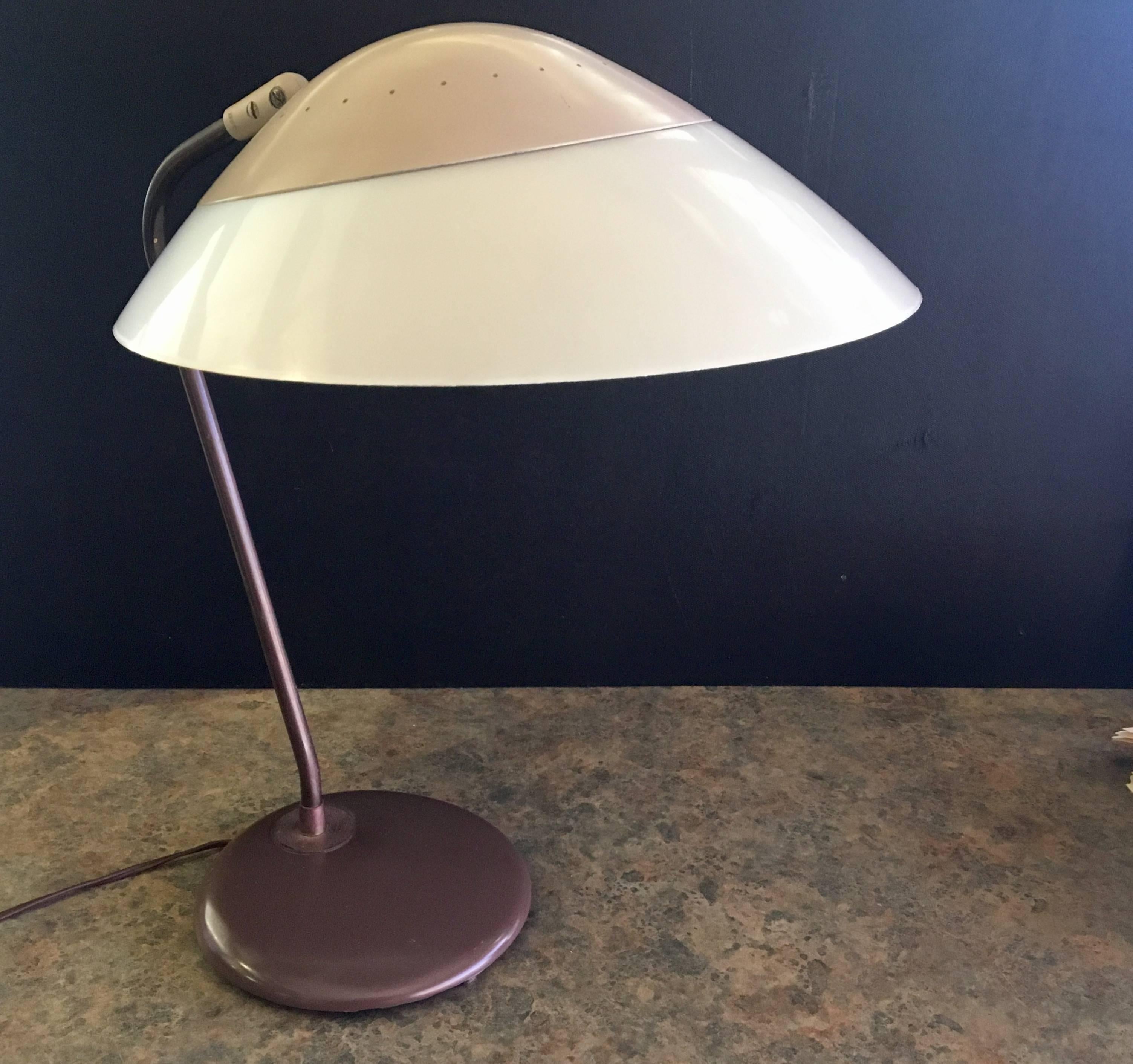 1950s original desk or table lamp designed by Gerald Thurston for Lightolier. Multi-Directional lampshade moves up and down and side to side with on / off switch. All in it's original vintage finish and condition with a hard to find plastic