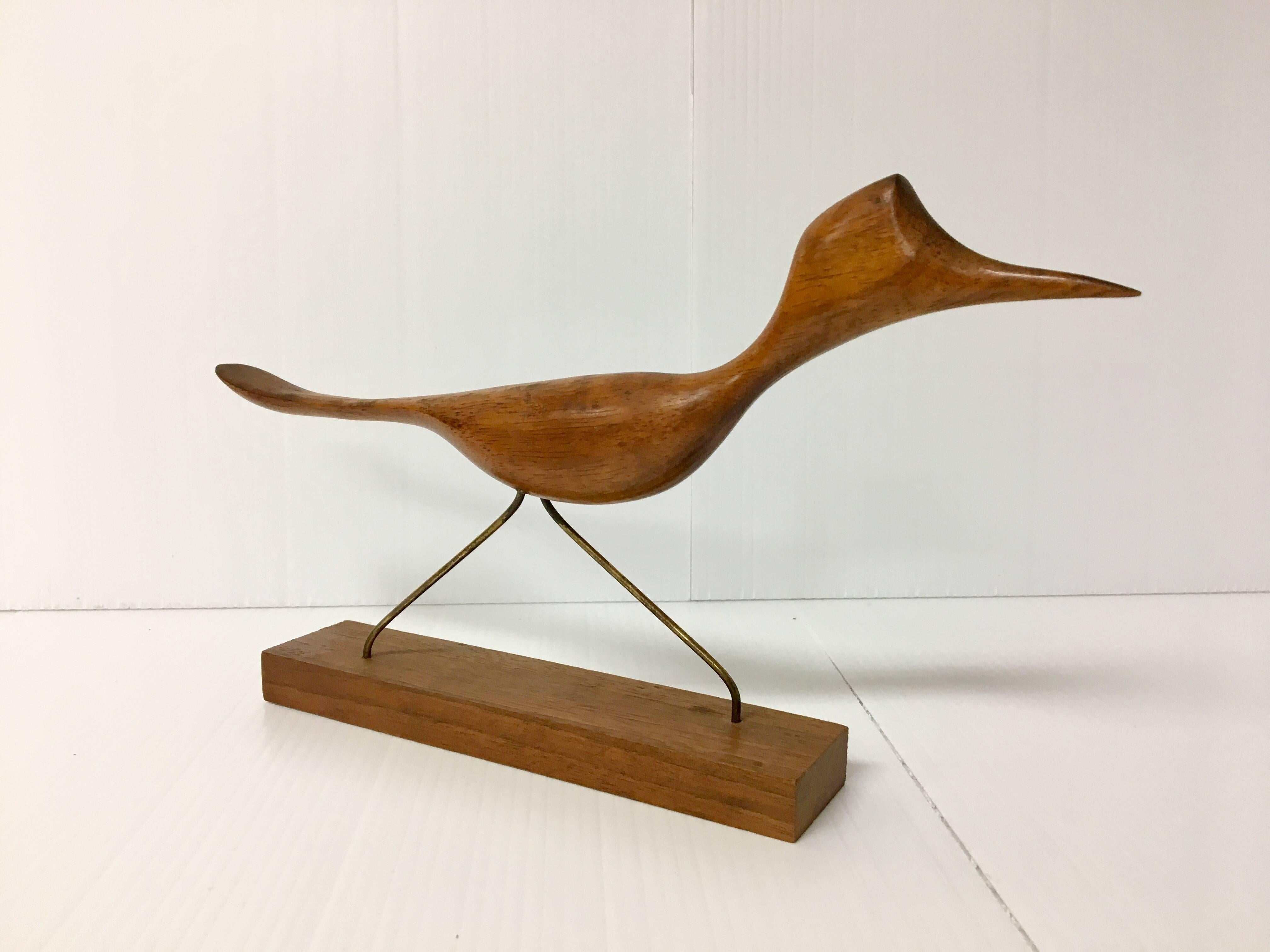 Whimsical koa wood roadrunner sculpture with brass legs, circa 1950s, made in California. Well sculpted piece.