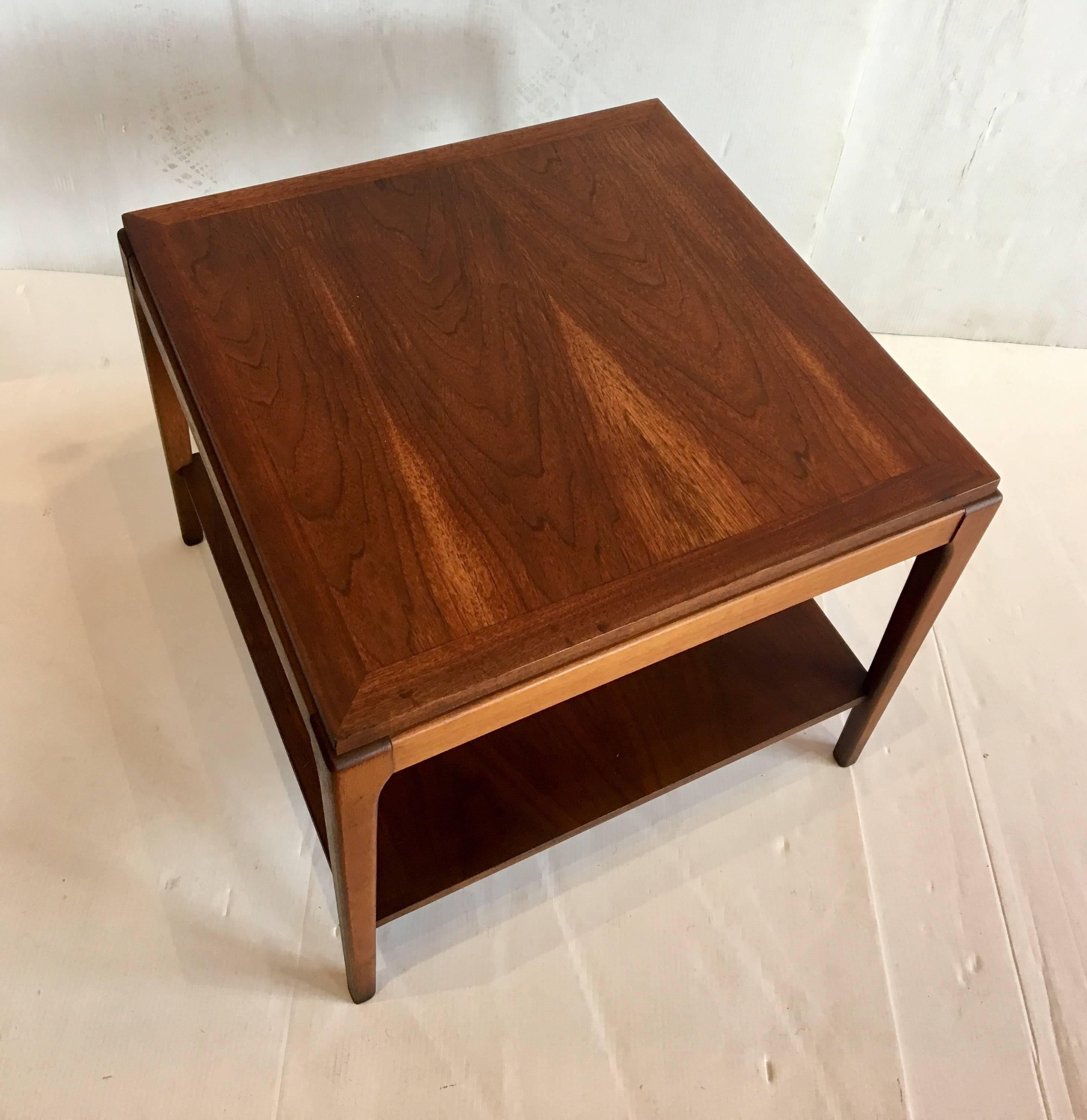 Beautiful and versatile square cocktail end table, circa 1950s freshly refinished and in great condition solid and sturdy with a magazine holder shelf on the bottom can be used as a corner table or in between two chairs.