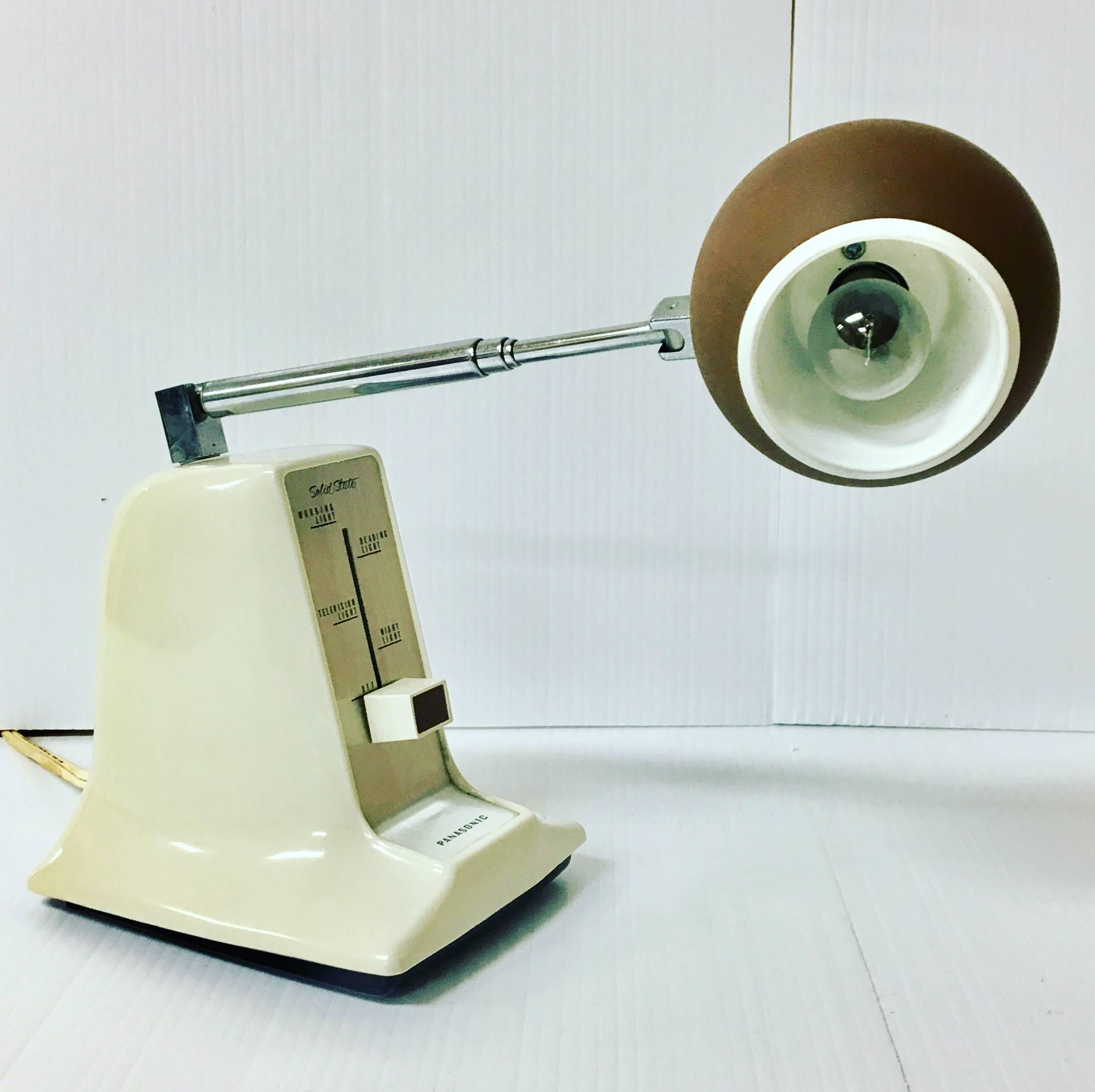 Cool and unique small telescopic eyeball desk table lamp by Panasonic (Model LS-201E). This unique lamp comes with a solid state dimmer switch; the eyeball rotates from side to side and the arm moves up and down. Excellent vintage working condition.