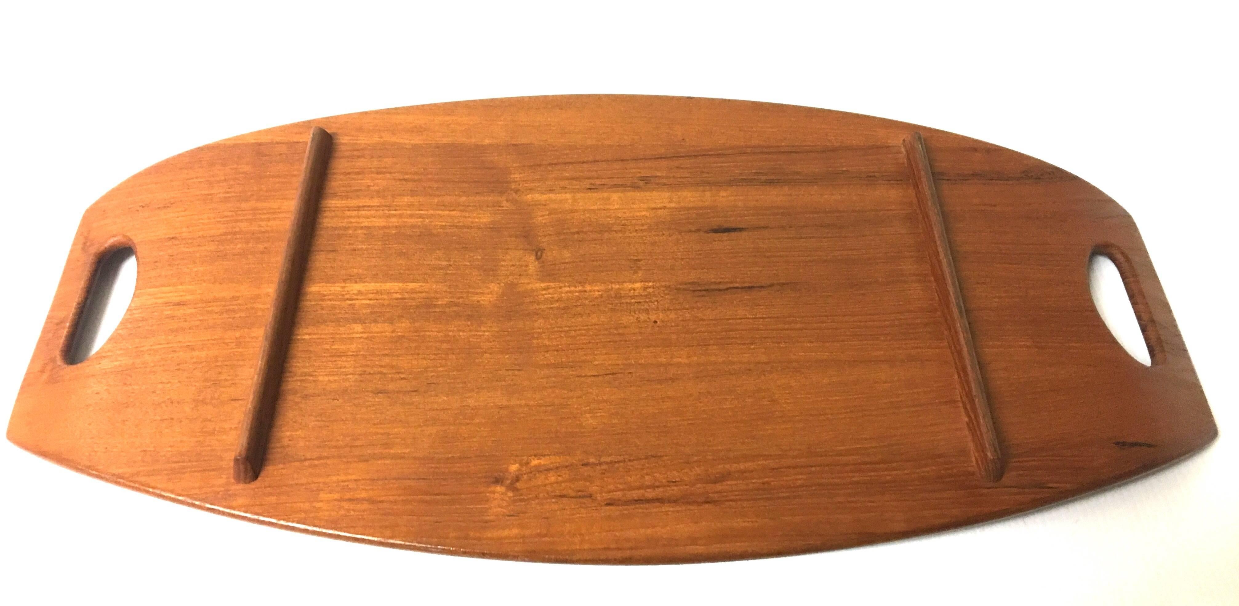 Beautiful solid teak gondola tray designed by Jens Quistgaard for Dansk; early production. Nice condition with raised edges and elegant lines. The large tray is 23 1/2
