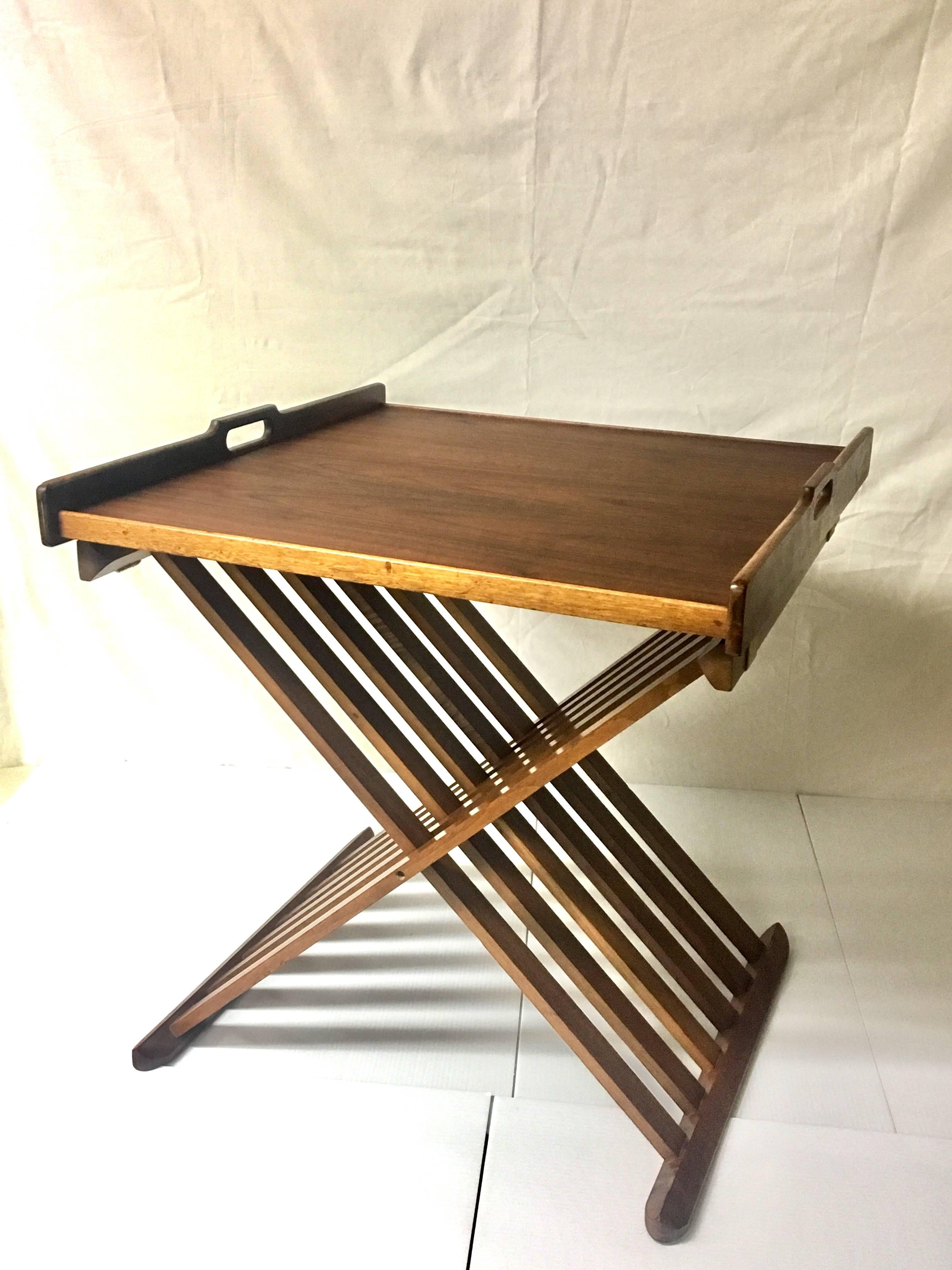 American walnut folding table designed by Kipp Stewart for Drexel, circa 1950s. The table is simple and elegant with a removable tray for easy storage. The piece is in very nice vintage condition and the tray has been recently refinished and oiled.