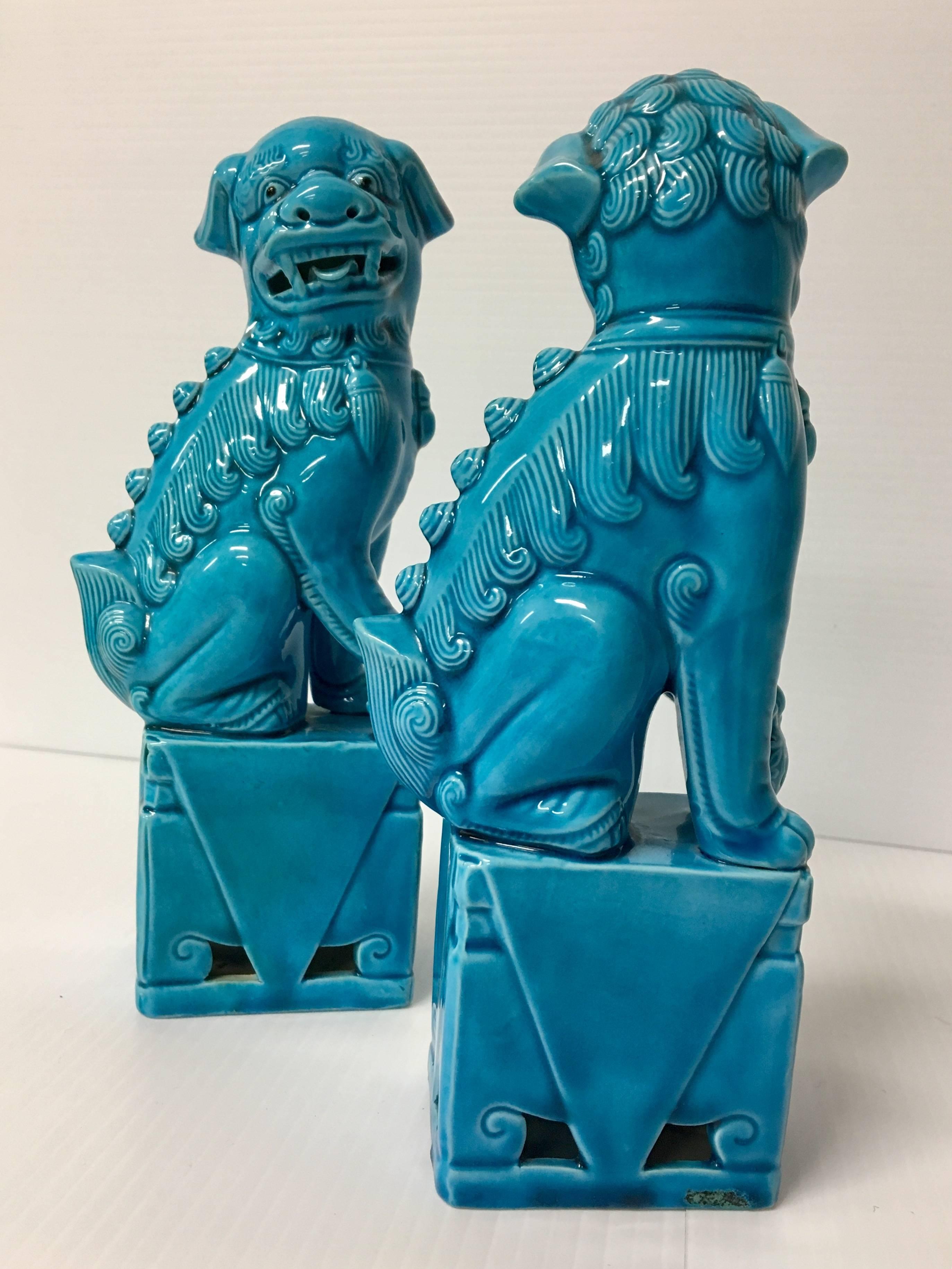 A very nice pair of vintage, turquoise blue, ceramic foo dogs from Japan. Excellent condition and patina; makes a great pair of book ends or a fun decor item in any room!