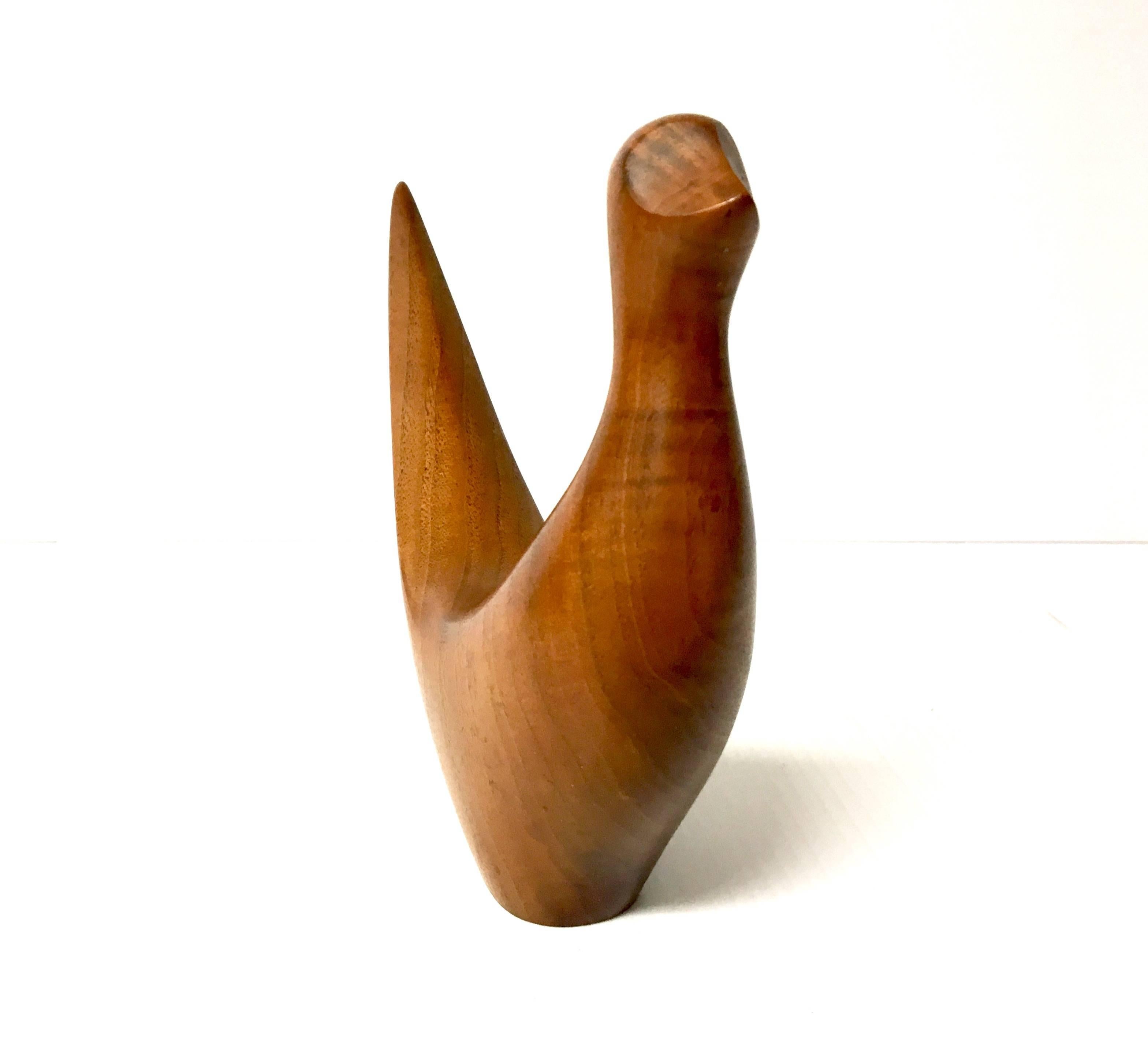 Well-crafted and sleek, solid walnut dove or bird sculpture, circa 1970s. Signed on the bottom 