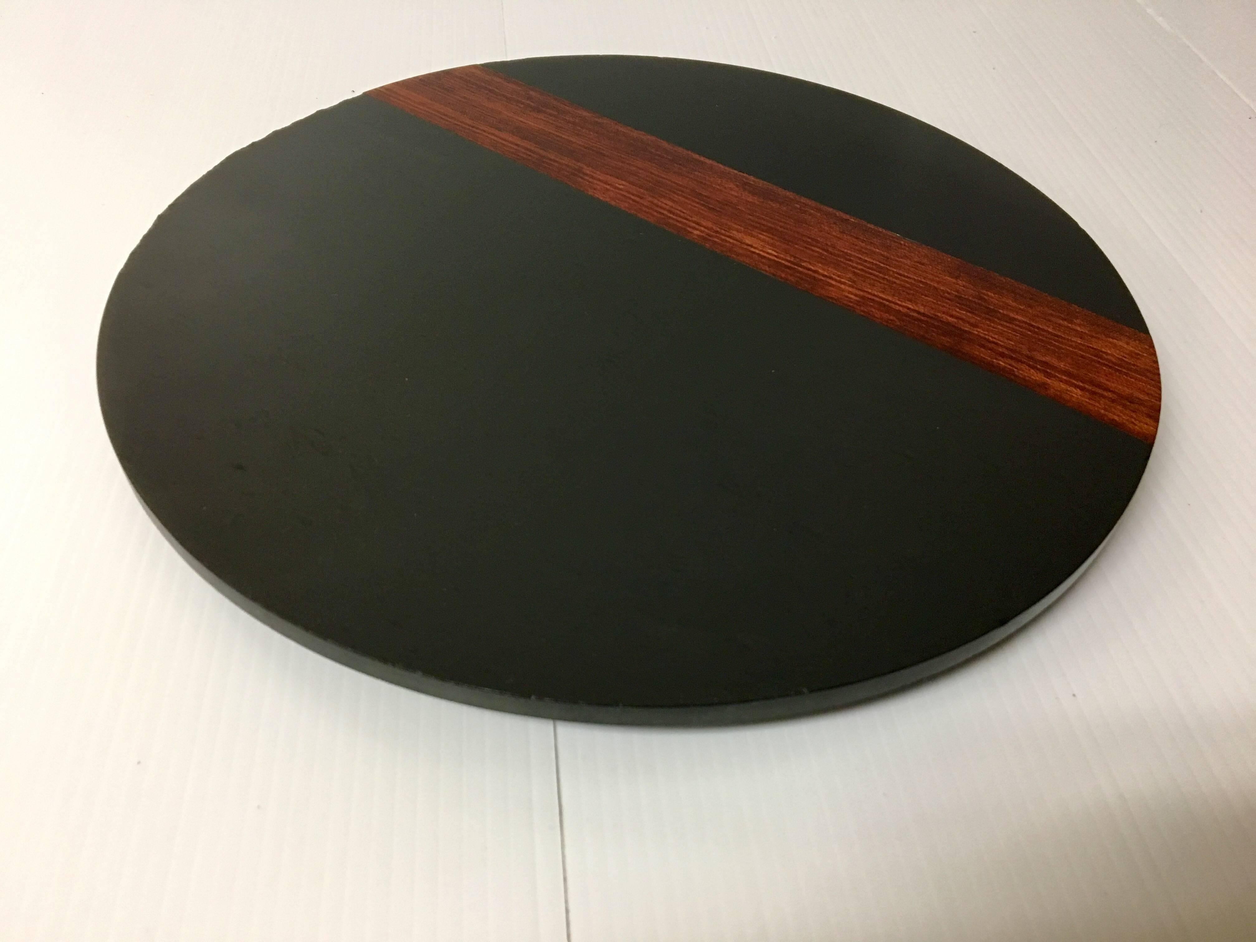 Unique, large (12"D) 300 million year old black slate and teak hardwood trivet by Harpswell House of Brunswick, Maine, circa 1960s. The piece is quite stylish and very functional. Some small fleabites around the edges, otherwise in excellent
