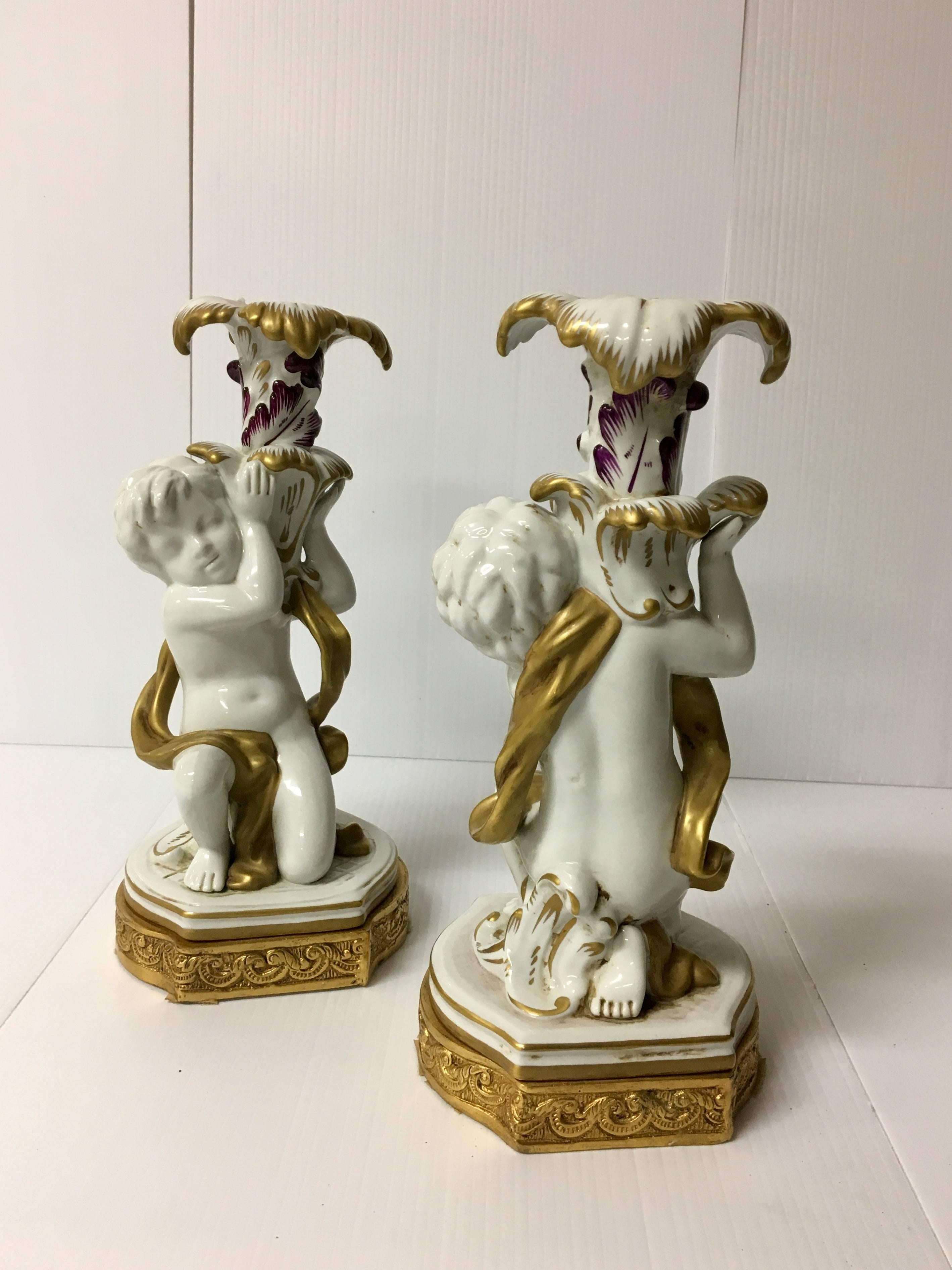 Elegant pair of porcelain, cherub candle holders by Capo Di Monte, circa 1970s. Made in Italy and signed with gold painted accents and a laced brass base. Excellent condition with no chips, cracks or crazing.