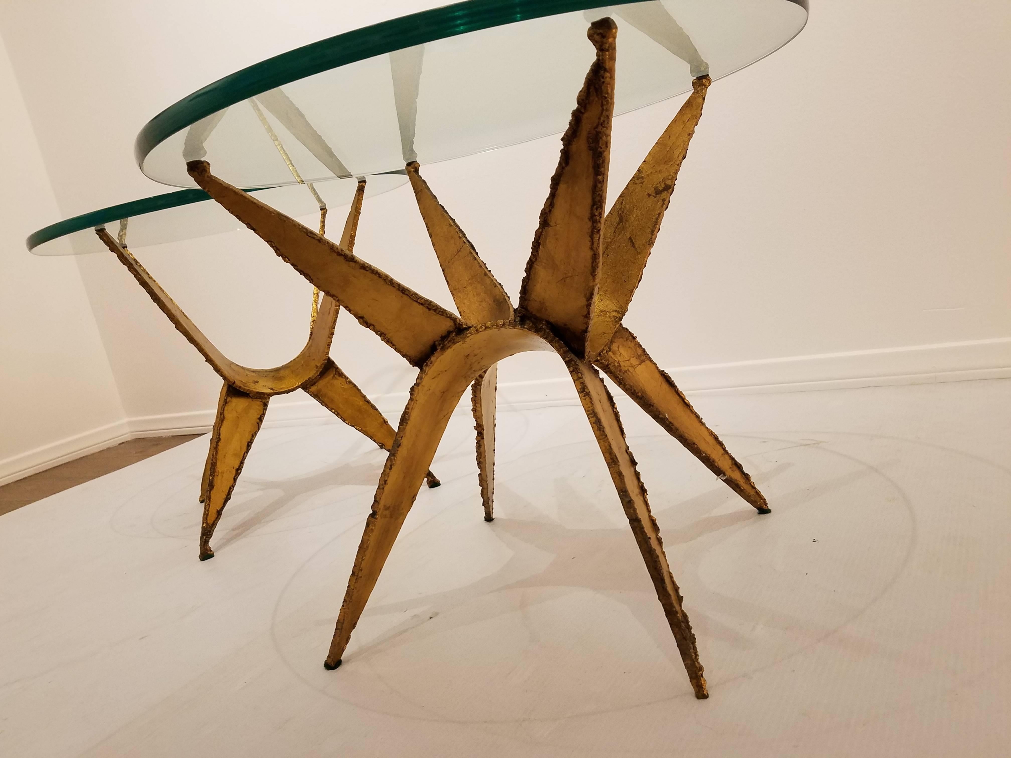 Nice and rare pair of small cocktail end tables. In the style of Daniel Gluck, circa 1960s, torch cut steel in a gold leaf finish, nice thick glass top.