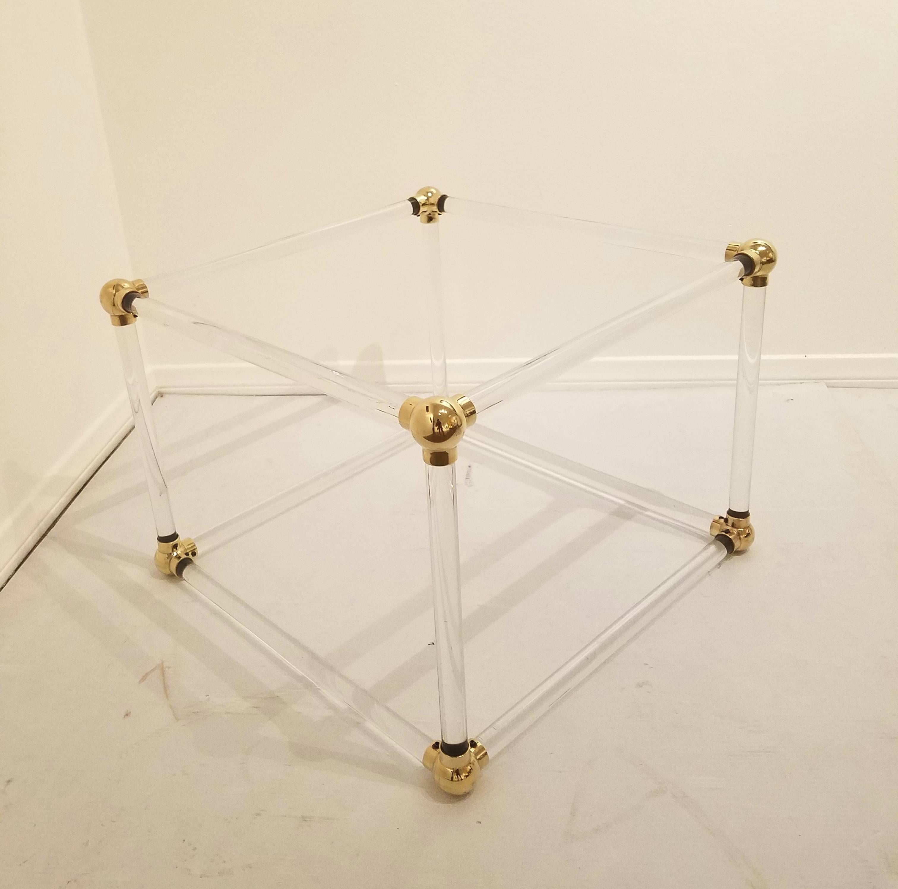 Unique Mid-Century Lucite cube and brass connector coffee table base, circa 1970s. The tubular Lucite poles and brass connectors have been freshly polished and it makes a very unique and stunning piece. It can be used as a coffee table with a square