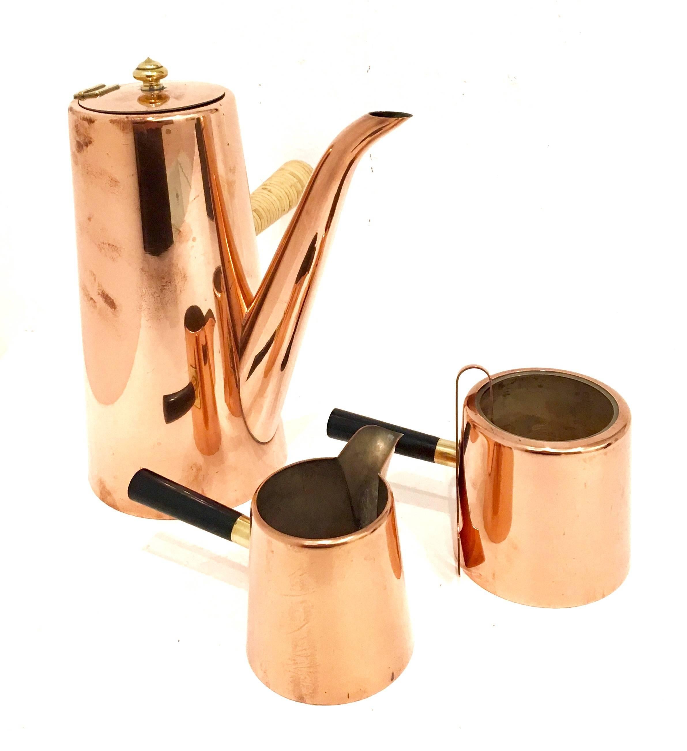 Elegant coffee set with cane handle in polished copper with sugar and creamer bowl, circa 1950s, comes with sugar tongs. With brass fittings and bakelite handles.