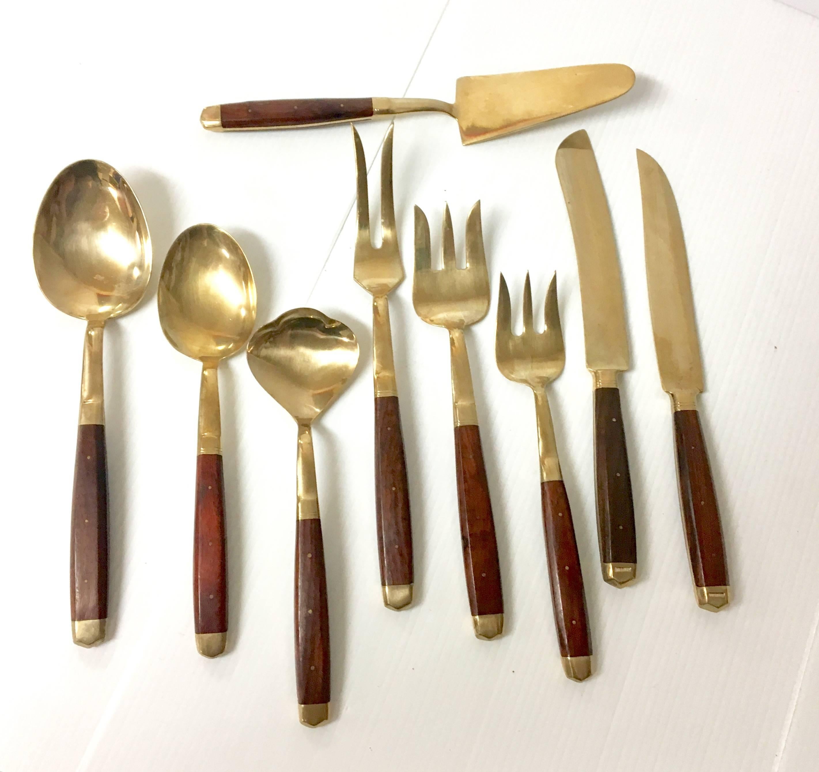 Elegant Mid-Century serving set of nine pieces; rosewood handles on solid brass. Set includes: Cake server, salad servers, serving spoons and forks and carving knives. Very cool set!