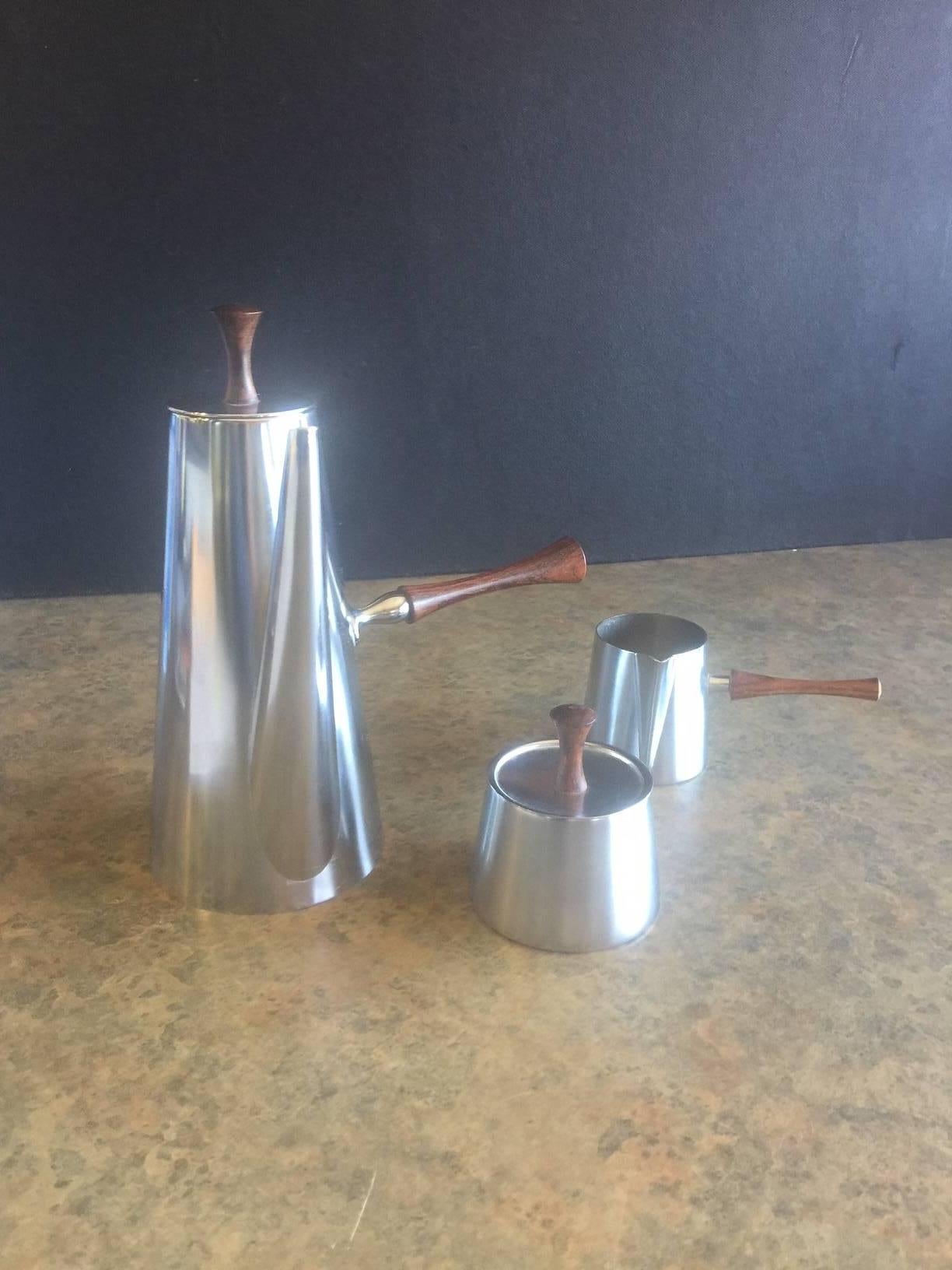 Very stylish three-piece, midcentury coffee set by Kalmar Designs manufactured in Italy. Each piece is made of seamless stainless steel with a solid teak handle. Very nice set in great condition.