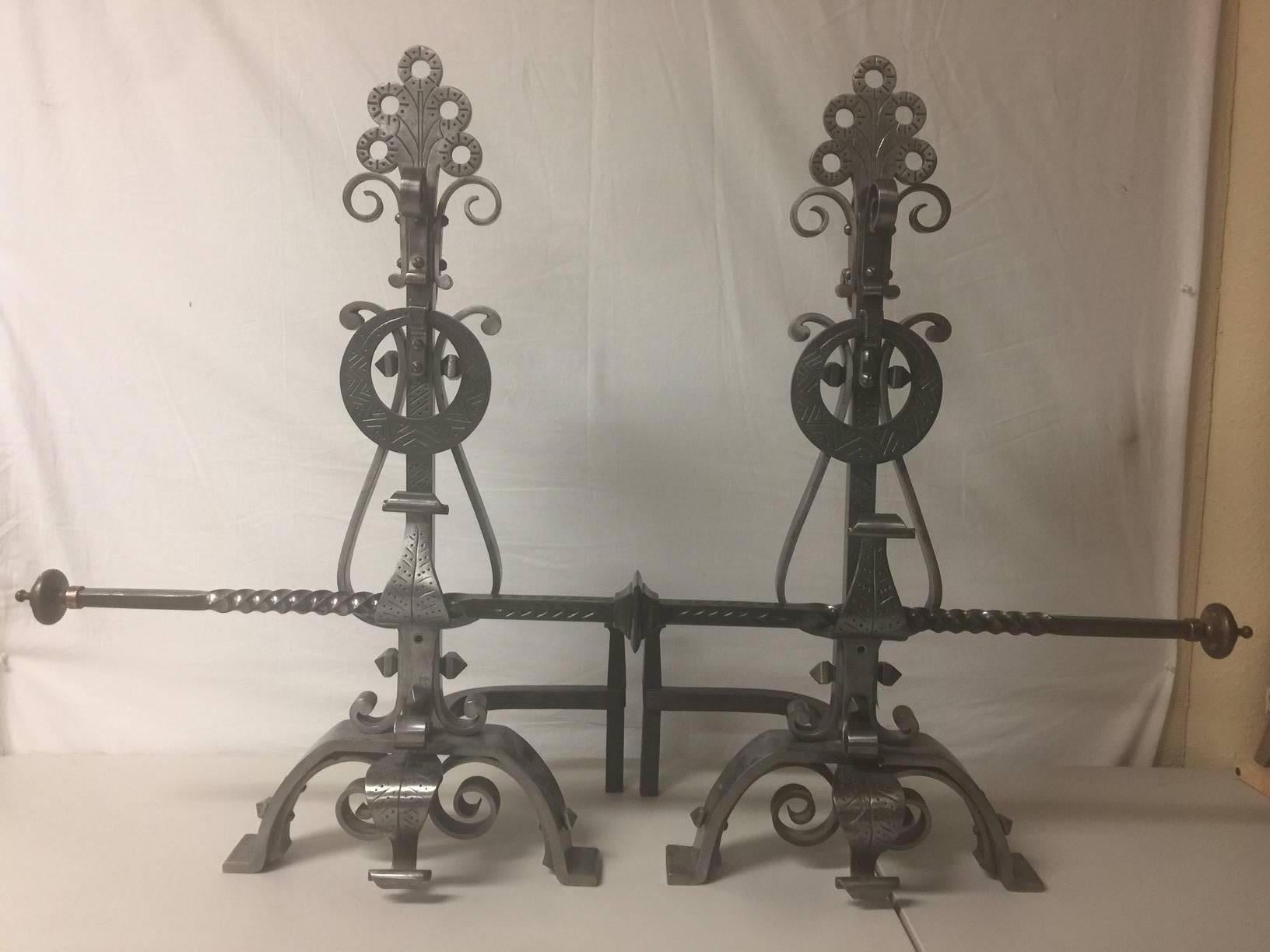 A very cool pair of extremely well made solid iron scroll andirons with matching cross bar.