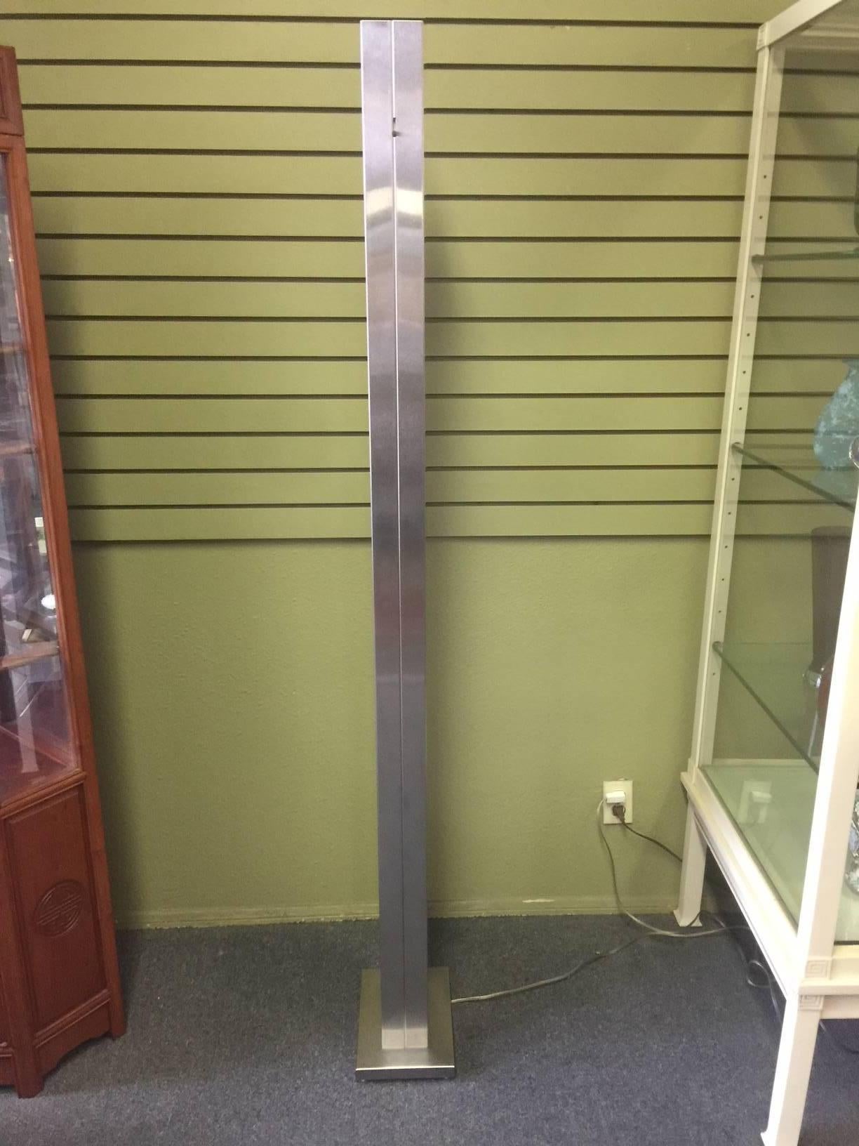 Massive, heavy and solid stainless steel torchiere floor lamp by Casella Lighting of San Francisco, circa 1970's. The piece has a brushed steel finish with a dimmer switch in excellent working condition. Great addition to any room!