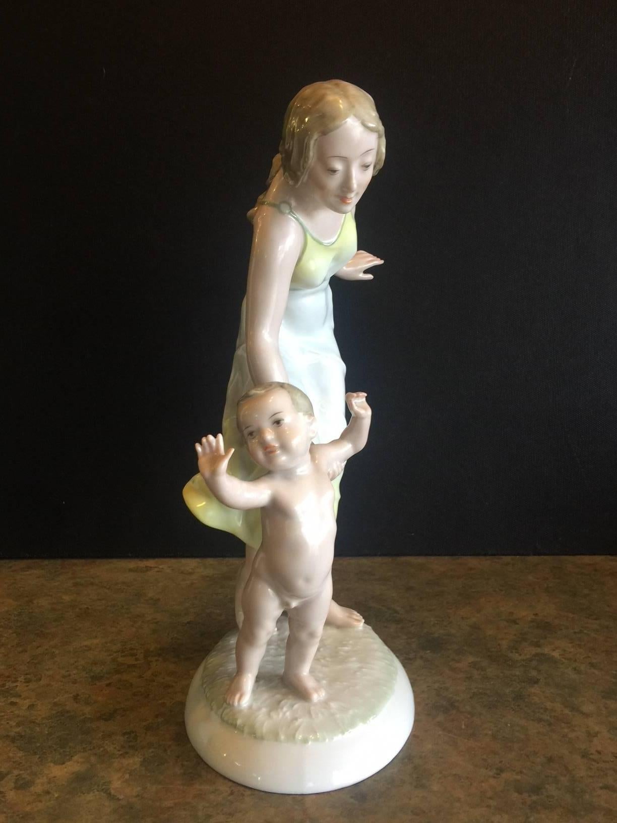 Wonderful porcelain hand-painted figurine of a mother & child by Hutschenruether of Germany. This is a very rare U.S. Zone piece, circa 1940s. The piece is 11.75" tall and is in excellent condition with no chips or cracks.