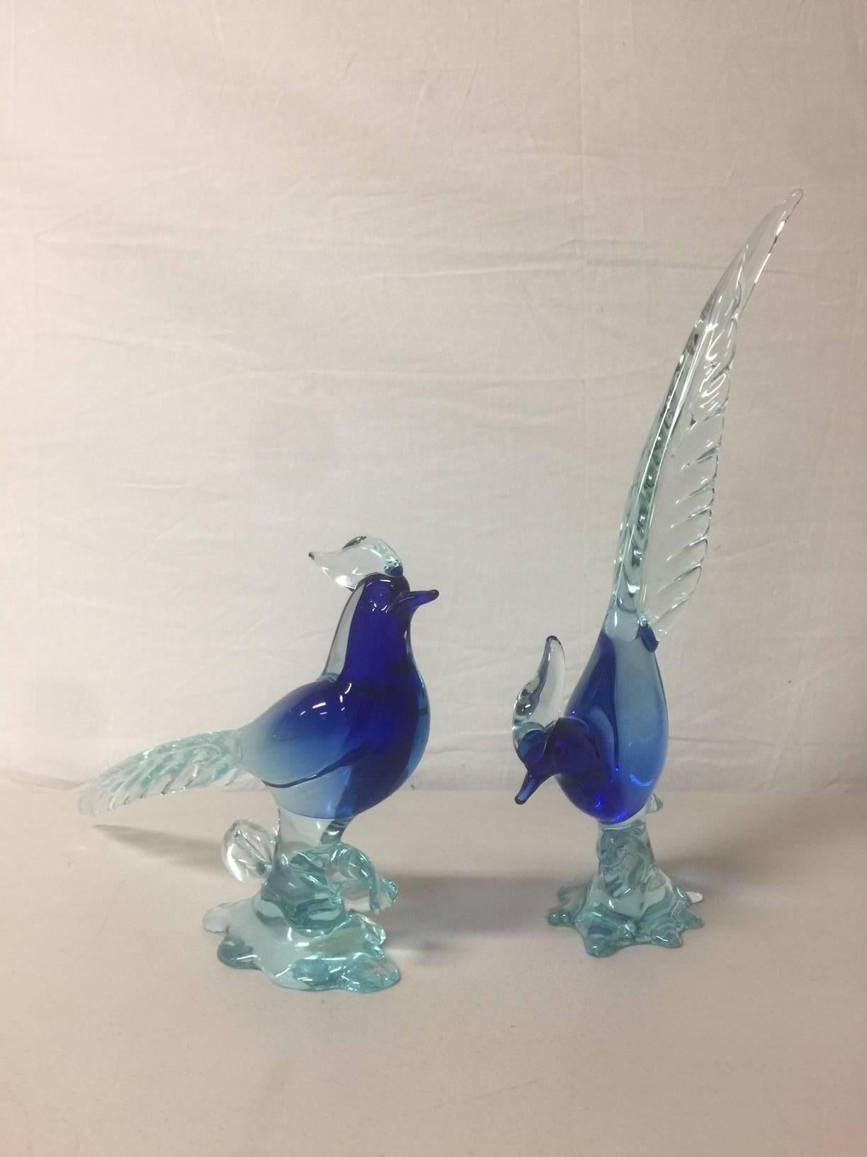 Nice pair of art glass birds/pheasants by Murano glass studios, circa 1960s in a blue / clear Sommerso style. Excellent condition with original Murano foil sticker attached to each bird.