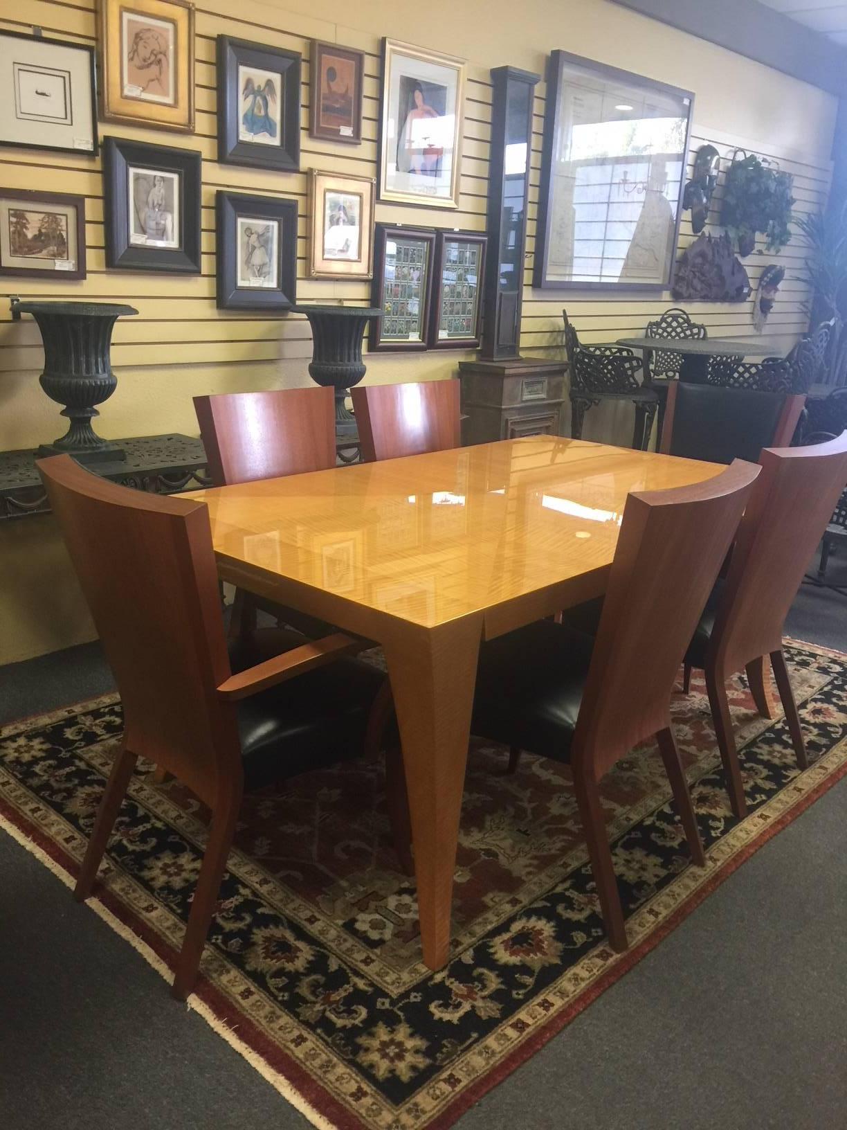 Absolutely gorgeous Aldabhra dining table and six chairs (two arm) by renowned designer and furniture maker Dakota Jackson. The table has dramatic carved legs with graceful curves; the tabletop has a mitered 