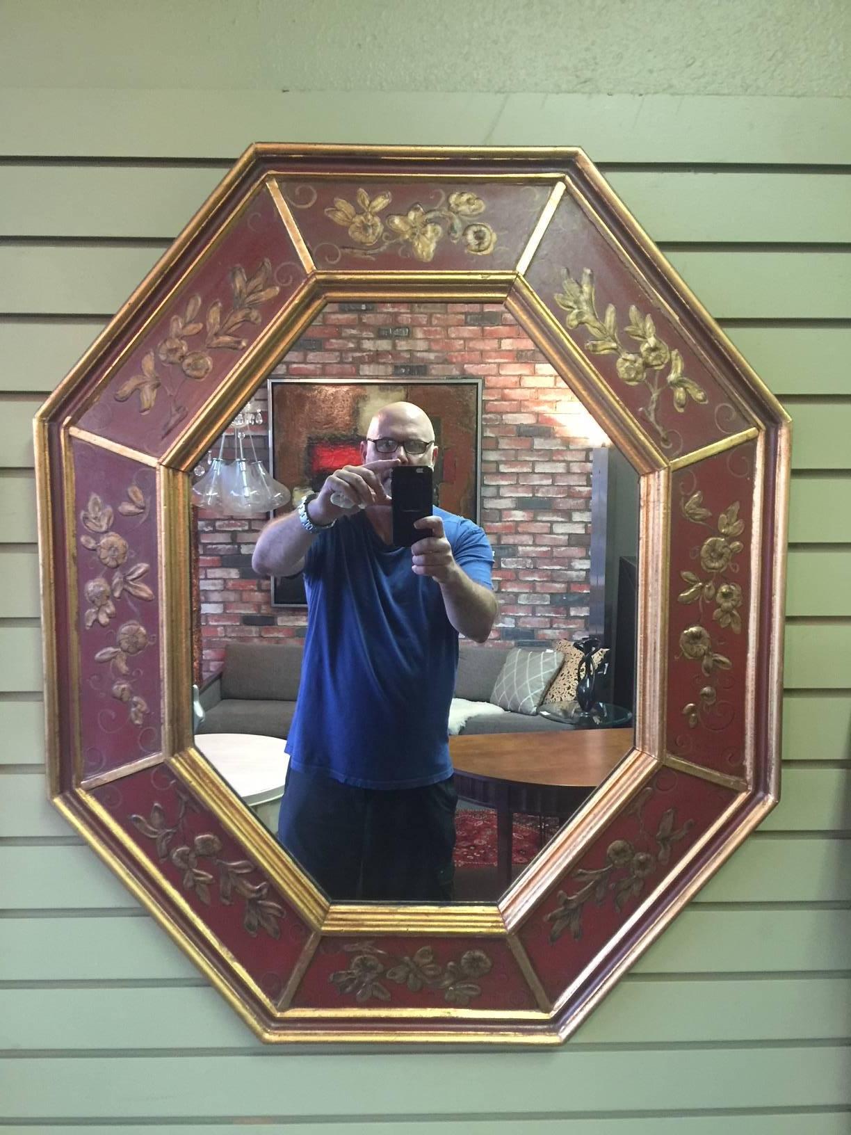 Inviting midcentury hand-painted gold leaf octagonal mirror in Chinese red by La Barge of Italy, circa 1960s. The mirror measures 35.5 x 29.5 and is in excellent vintage condition retaining its original tag.