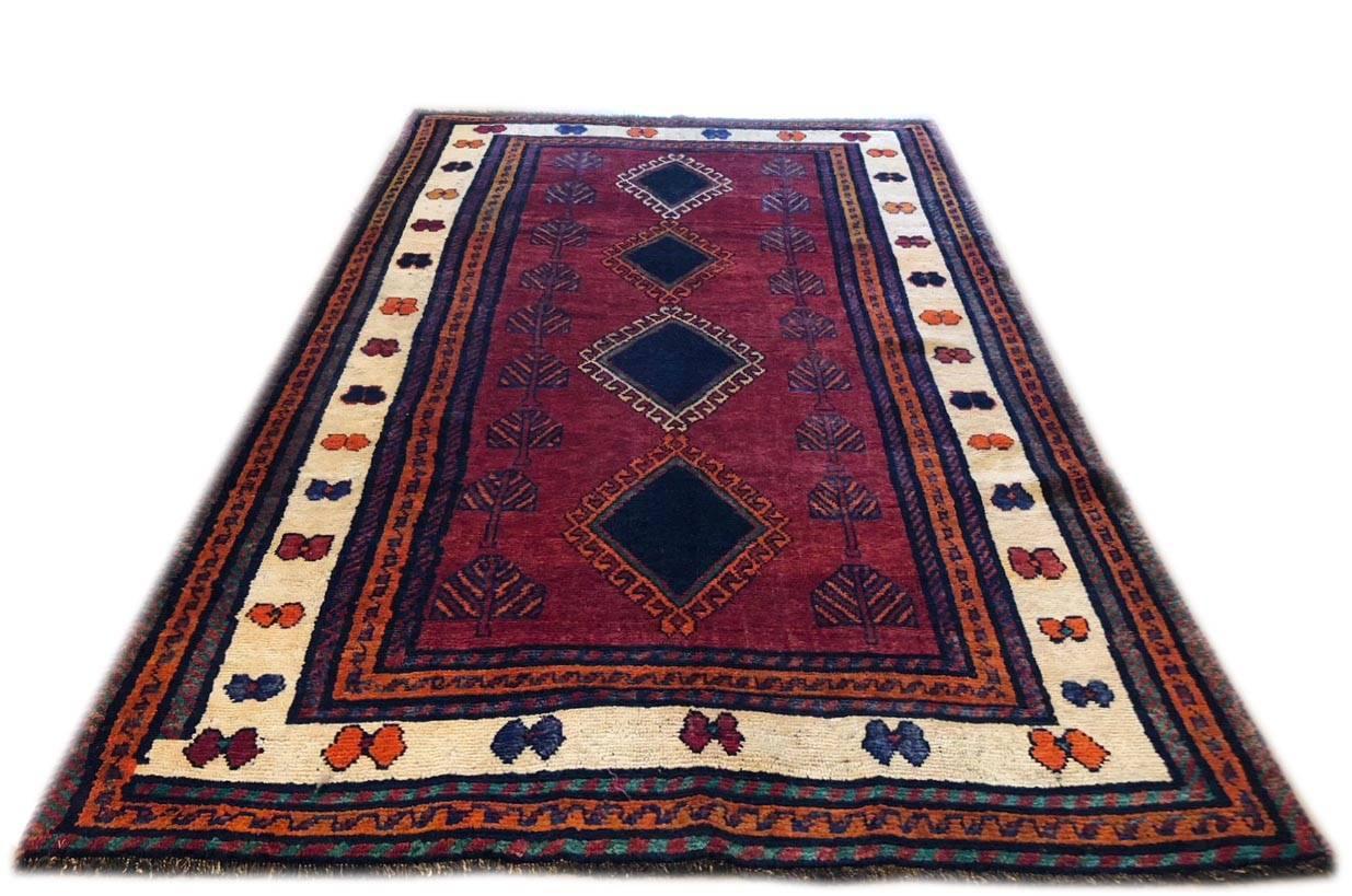 This carpet is knotted in the province of Fars in south west of Iran. Shiraz rugs have tribal and nomadic design and usually the dominant colors is bright red like this beautiful piece. The pile and foundation is wool. This rug is rustic in a good
