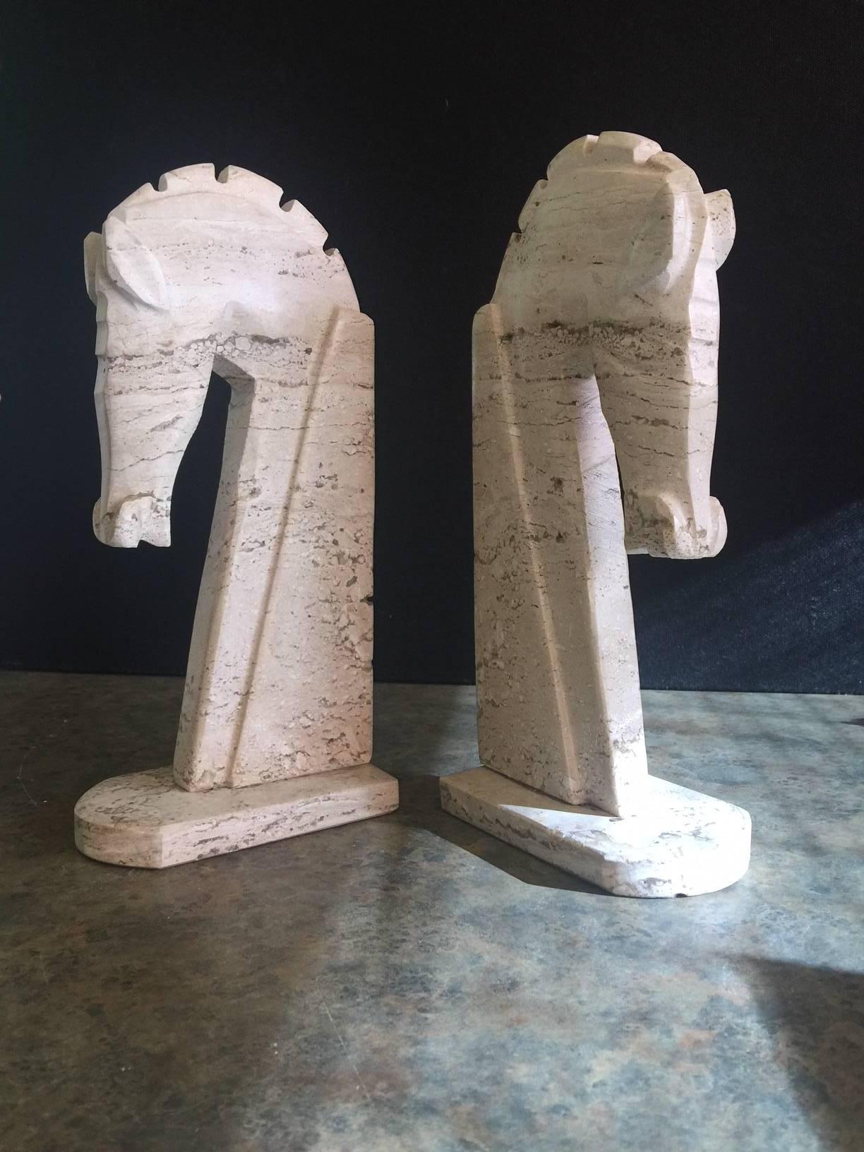 Very stylish pair of mid-century Italian travertine horse head bookends, circa 1970's. The bookends are heavy and solid and well crafted. They wold make a great addition to any office or den.