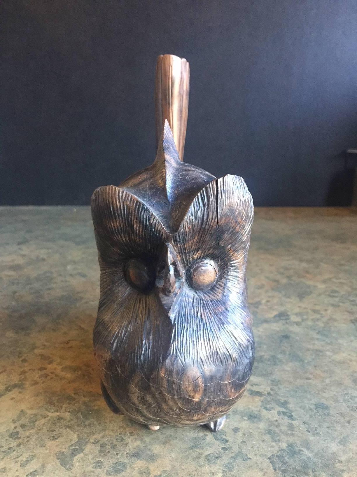 A very cool mid-century hand carved owl sculpture made of zebra wood.  The piece has tremendous detail carved around the entire sculpture.
