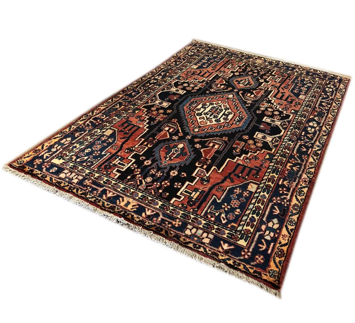 This piece is Persian Hamadan with wool pile and cotton foundation. Persian Hamadan rugs are easily recognized with their pattern and color combinations. The colors in this piece is indigo blue, cream, light blue and rose. This rug has a very