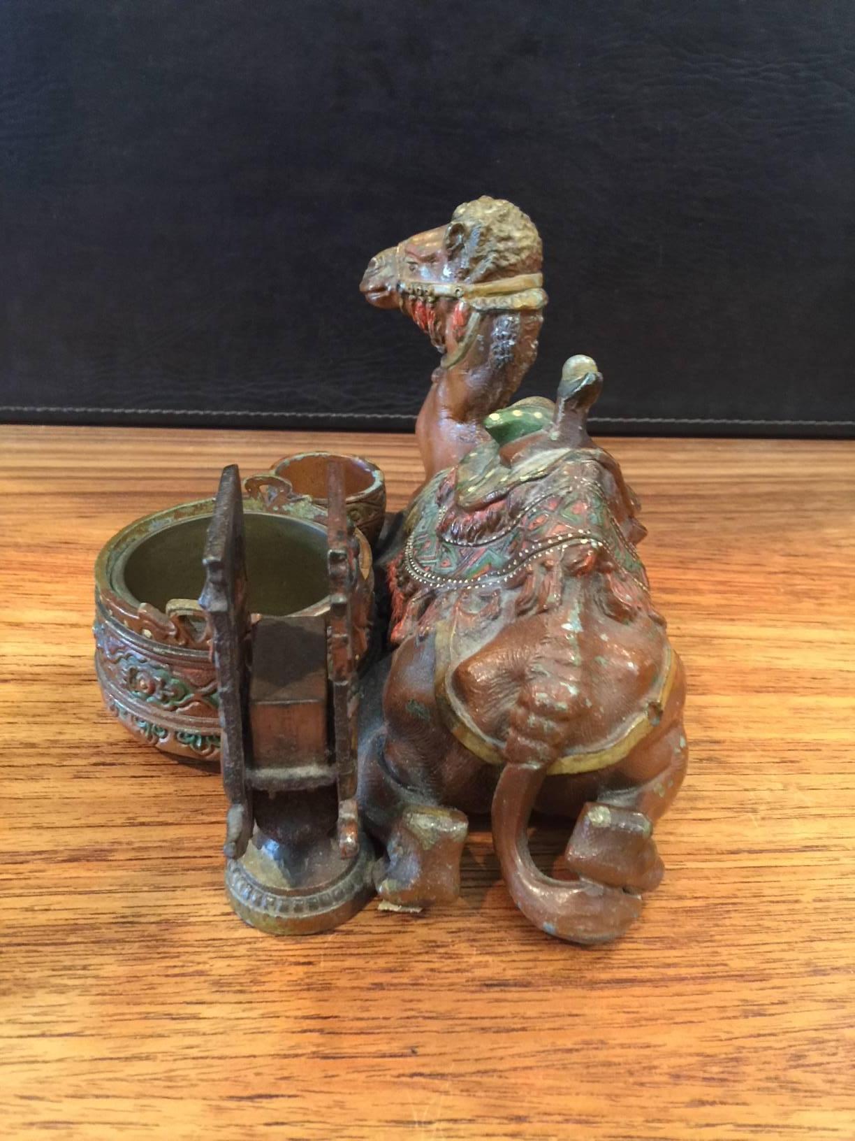 Unique white metal, cold painted, antique camel cigarette stand from Austria, circa 1900. The stand is in good shape with some chipping to the hand-painted camel (please see pictures).