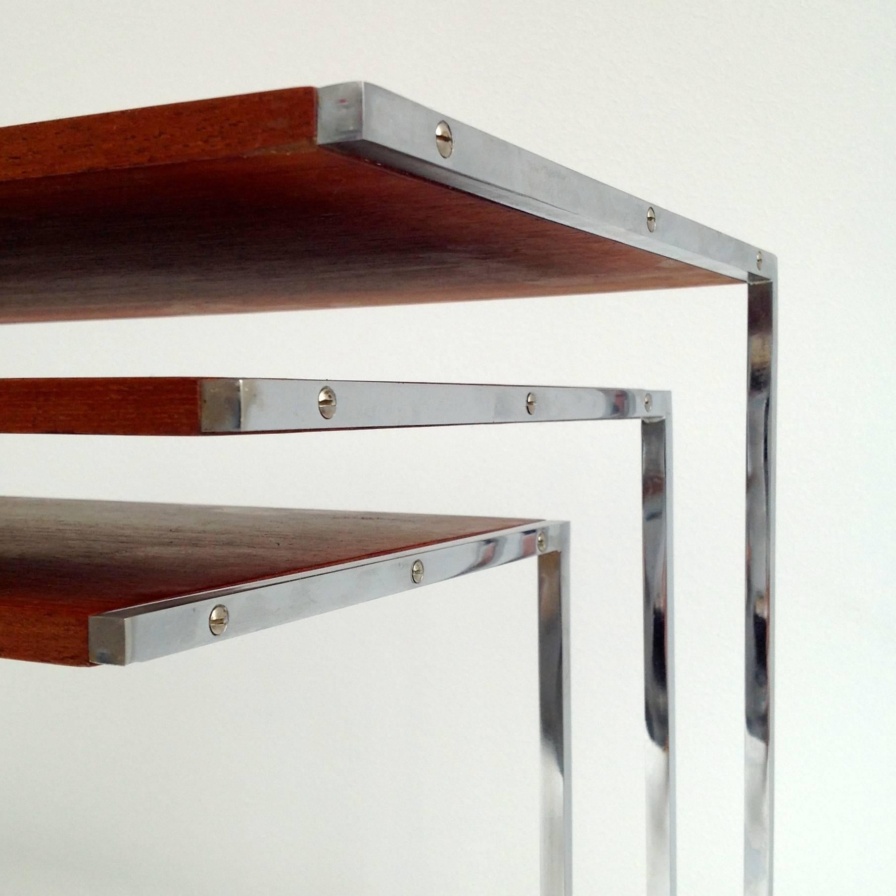 Nice iconic original design, set of three nesting tables.
Made from chrome-plated solid steel and beautiful flamed teak tablets.

Dimensions:
Small: 11.81inch (30cm) H x 12.60inch (32cm) W x 9.84inch (25cm) D.
Middle: 13.78inch (35cm) H x