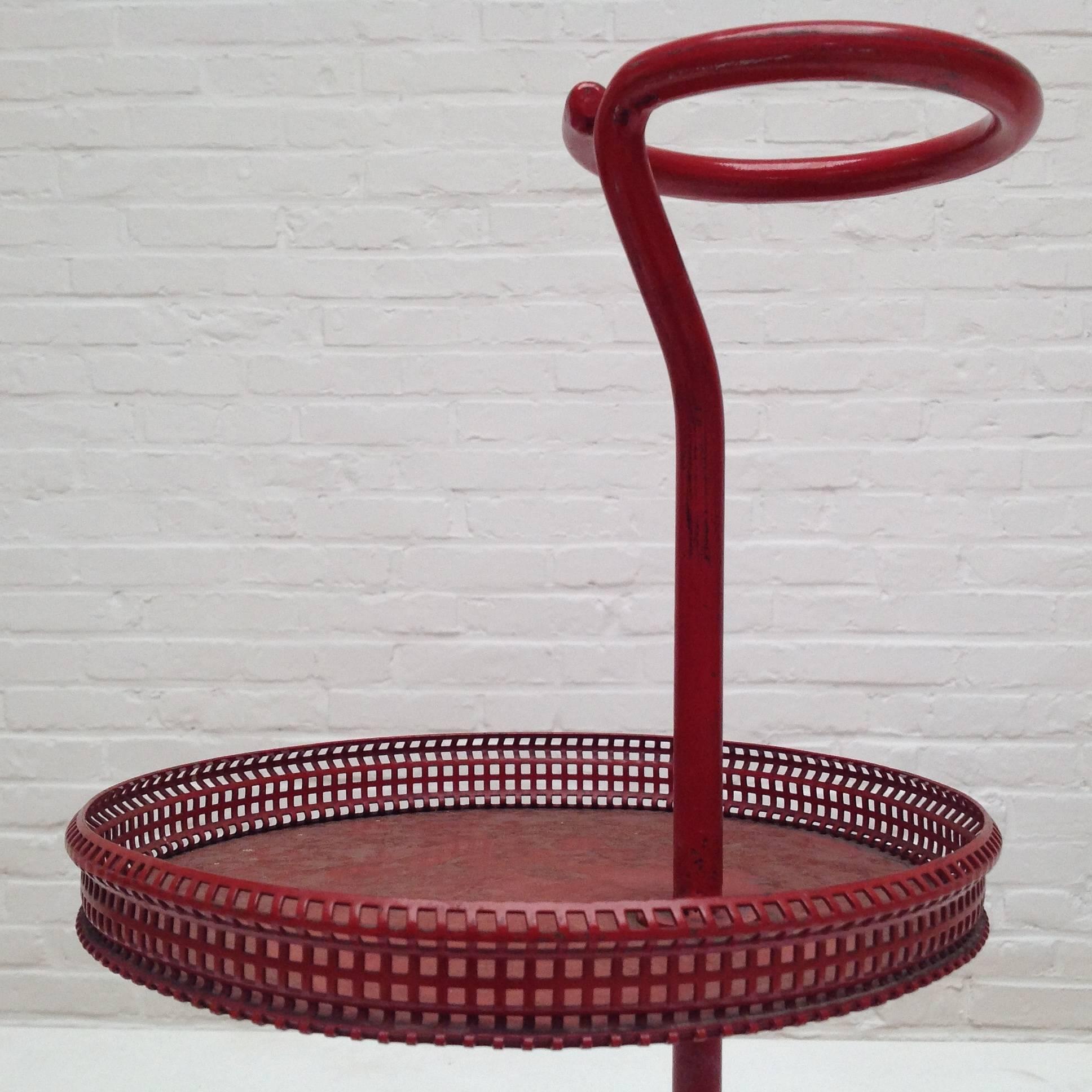 Enameled metal bottle and glass holder designed by Mathieu Matégot.
Manufactured by Ateliers Matégot (France), circa 1950.
Lacquered perforated metal with original wine red paint.
In good original condition, with minor wear consistent with age