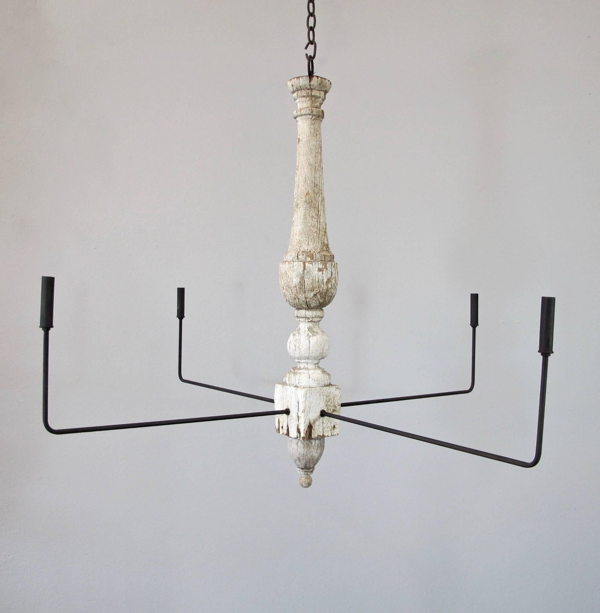 Stunning pair of chandeliers created with aged antique wood and new modern arms. Wood has original aged patina with white coloring and arms are metal with aged black finish. Four candelabra base lights up to 60 watts/socket. All new wiring, UL