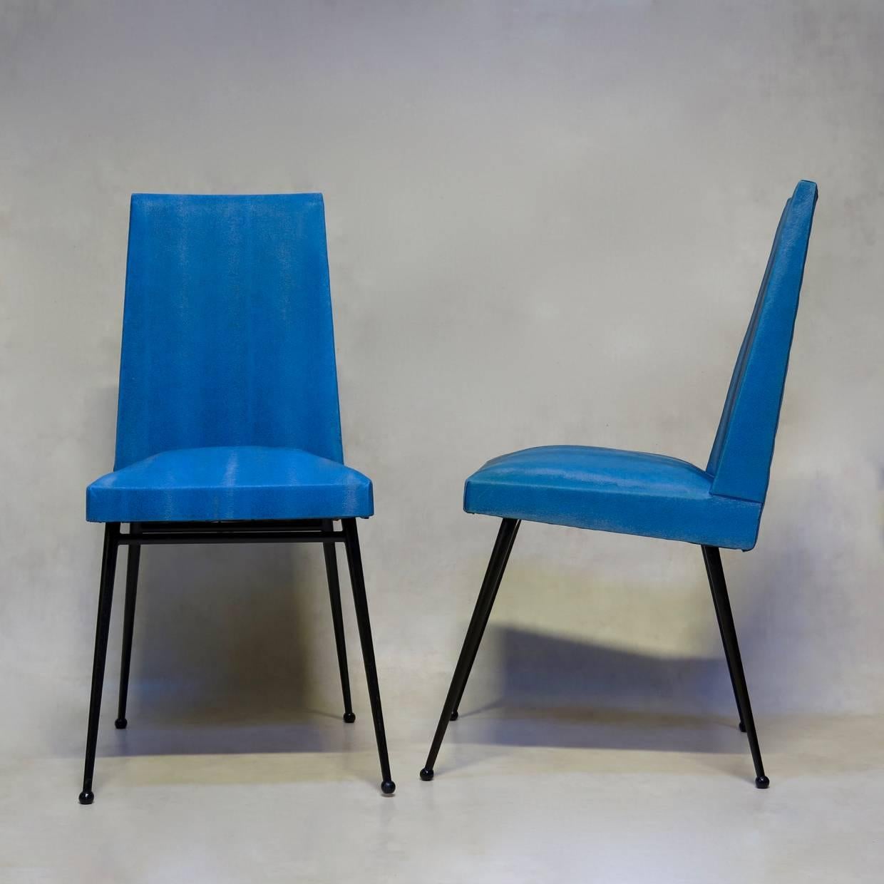 Nice set of four dining chairs with nice, graphic lines. Upholstered in textured blue vinyl.