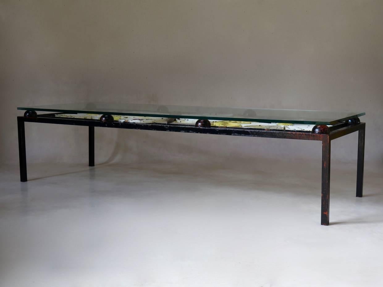 Unusual and charming wrought-iron coffee table. The table top has a lovely buttelfy and flower decor in nice colours, and is covered with a thick glass top.

Four available.