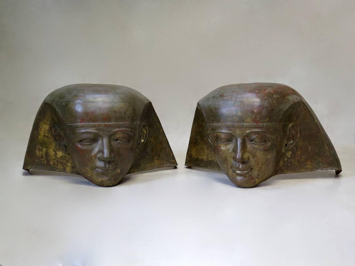 Unique and wonderful pair of large pharaoh heads made as theatre props out of fiberglass, with a lovely antique gold patina with traces of red showing beneath.