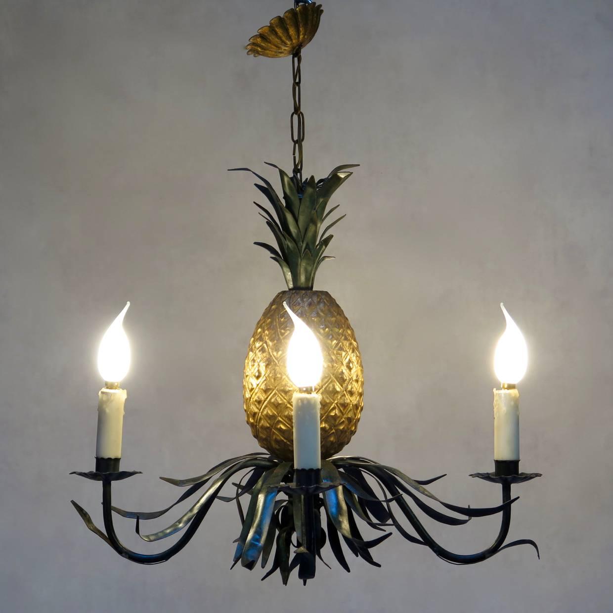 Fun and rather lovely painted iron and tôle four-light chandelier from the 1940s-1950s. The body is painted gold and the leaves and arms shiny dark green. Complete with original chain and rosette.