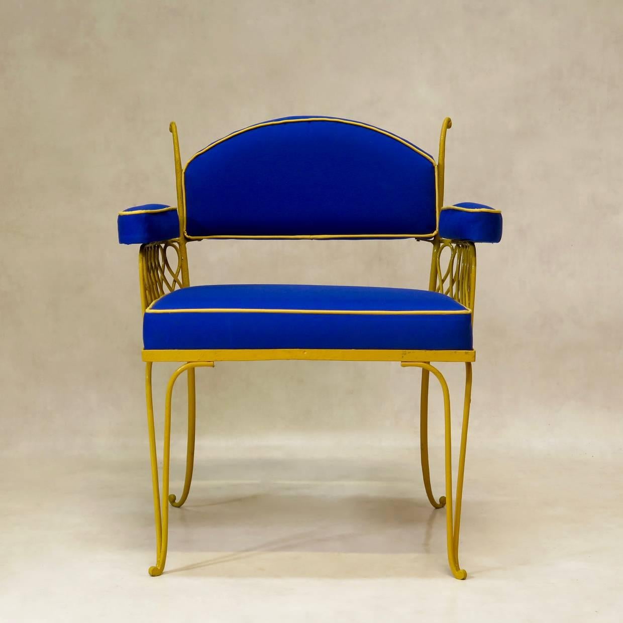 Chic and fun pair of Art Deco garden chairs by René Prou, with a yellow-painted wrought iron structure and newly-upholstered blue canvas seats, backs and armrests, with yellow piping.