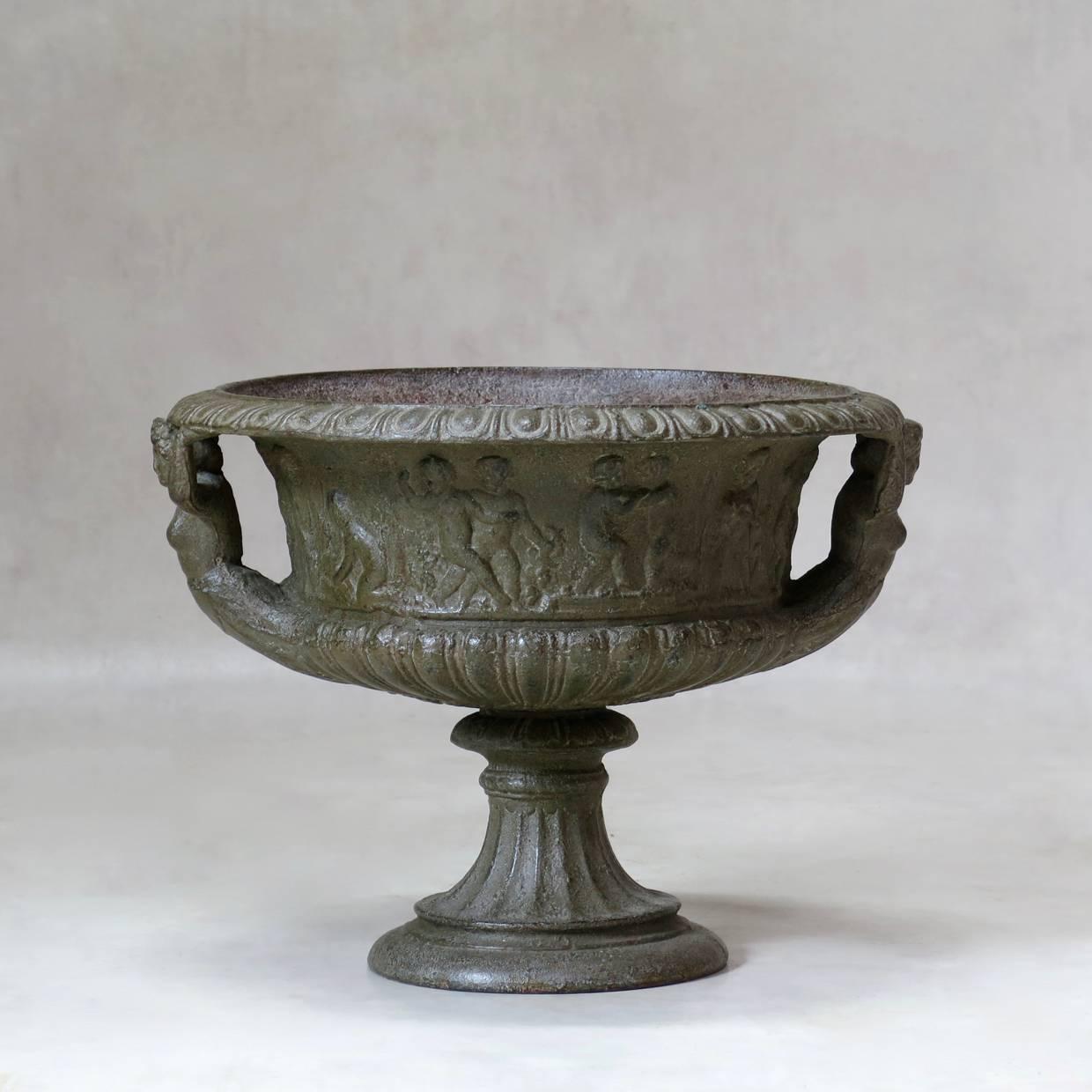 Classical pair of 19th century cast iron urns or planters with a dark silver/grey patina.