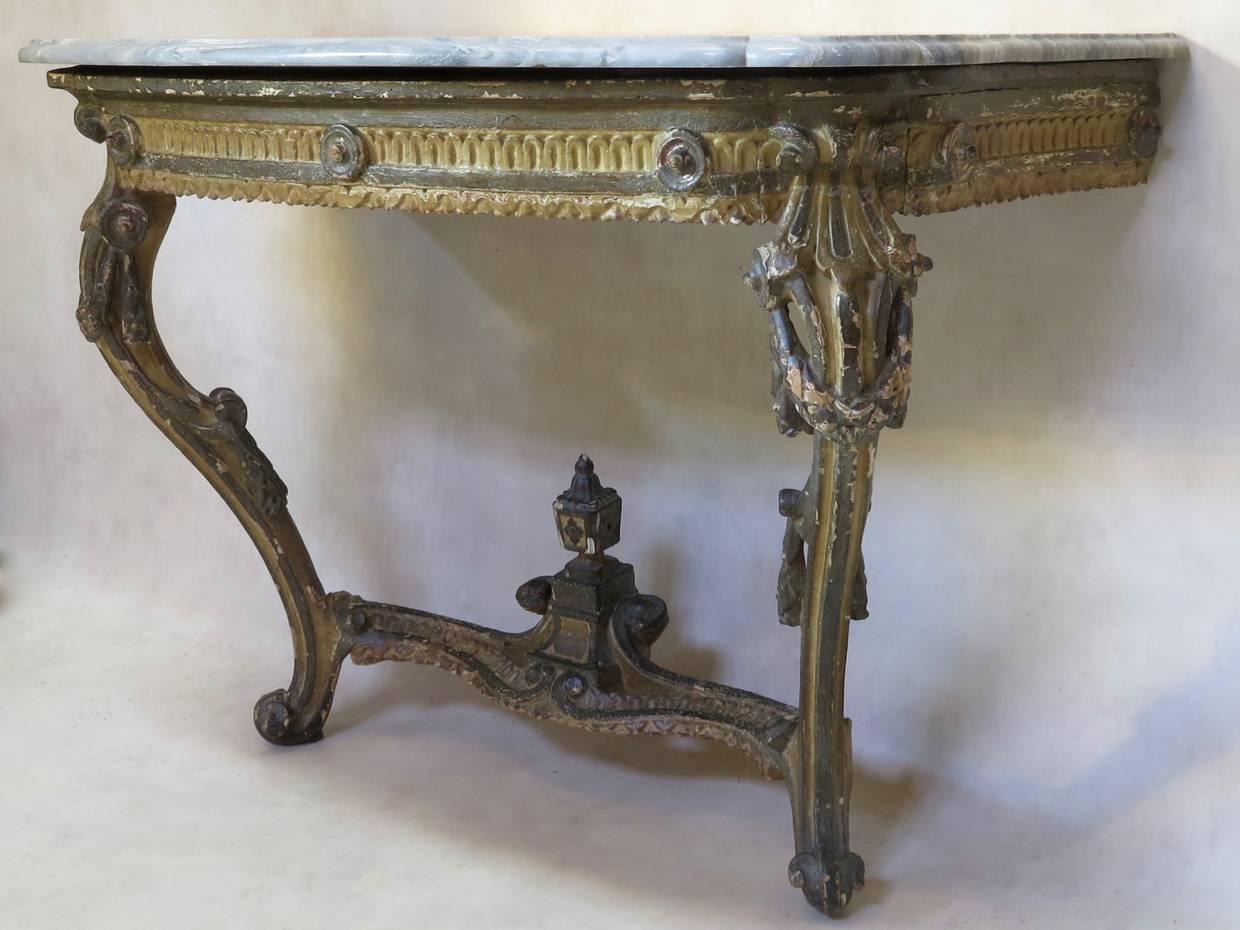 Rare and wonderful pair of elegant, Transition era (between Louis XV and Louis XVI) hand-carved console tables. Beautifully aged two-tone paintwork. Original 