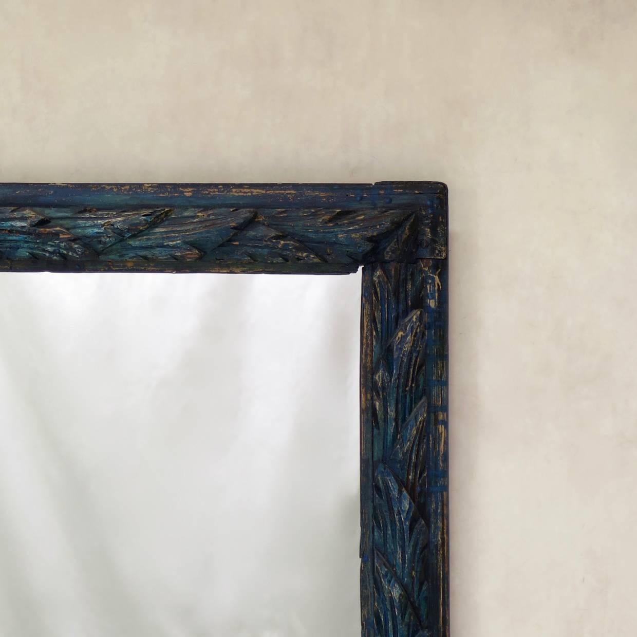 Elegant and rare pair of pinewood frames carved with a repeating acanthus leaf motif, painted dark blue. Fitted with new mirrors.
