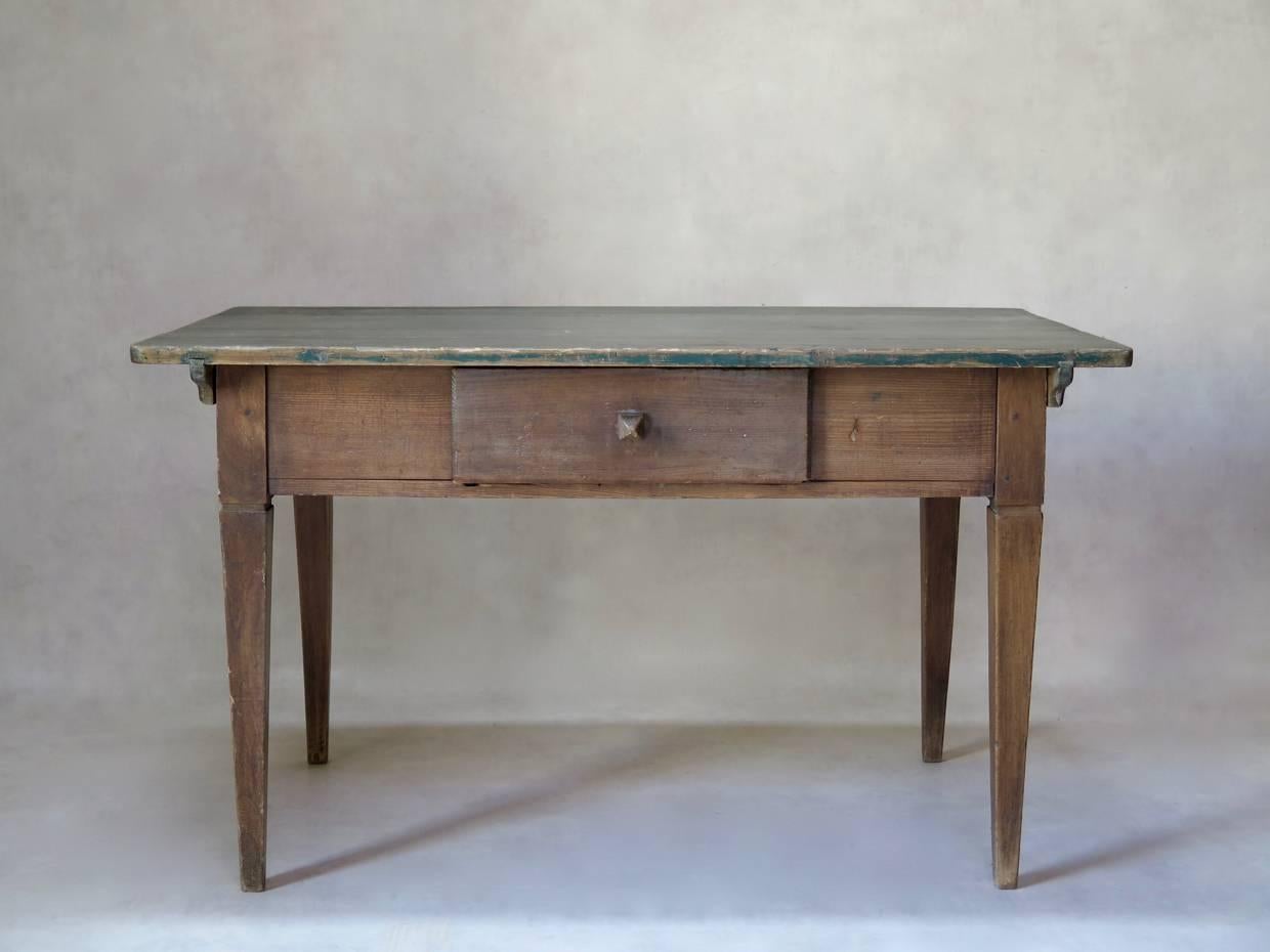 Charming pinewood table with single drawer and original green-painted top, raised on tapering legs.